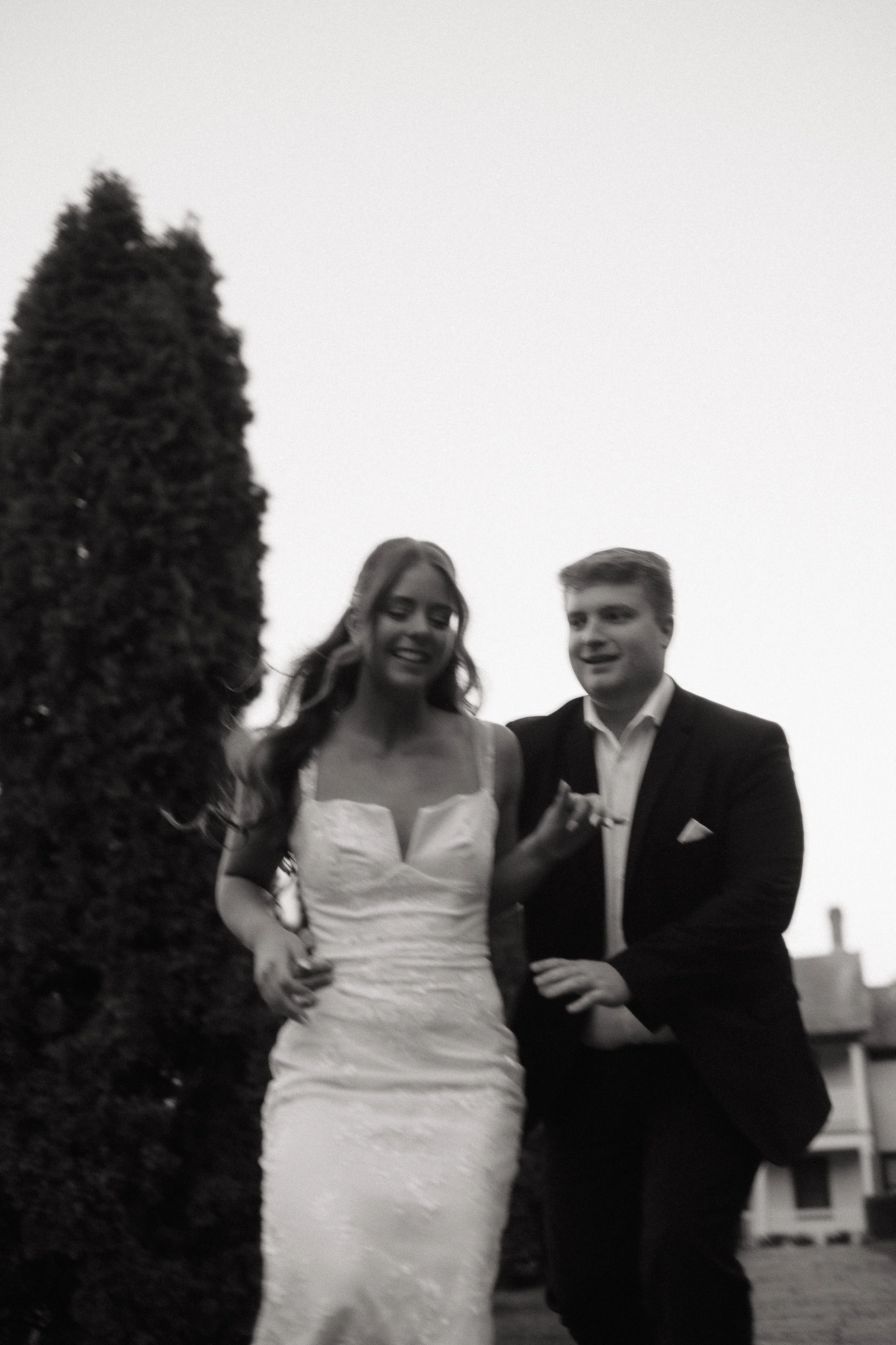 Playful couple moment during an engagement session at Battlefield House and Museum in Hamilton Ontario, photographed by James and Alyson Photo