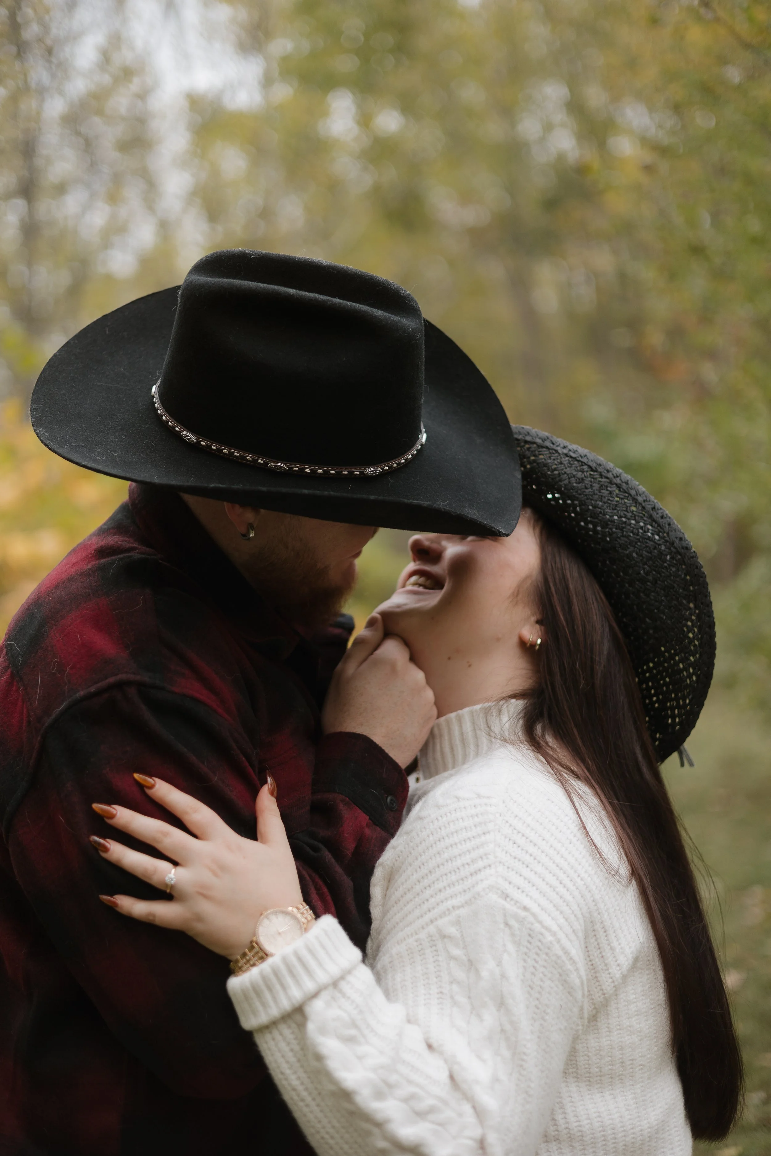 Engaged couple wearing cowboy hats in Paris Ontario