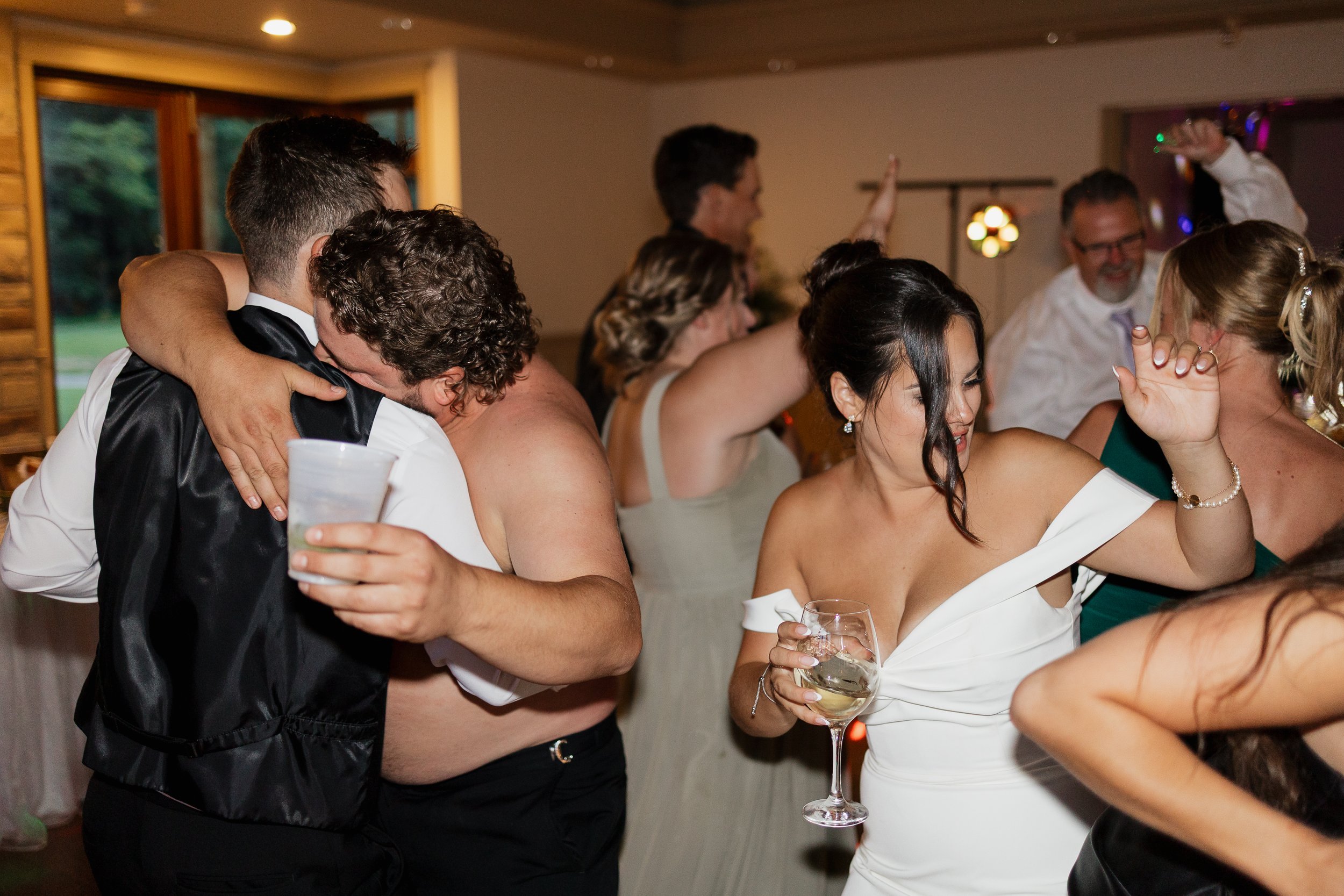 fun candid moment of the dancefloor, Ontario wedding photography by James and Alyson Photography