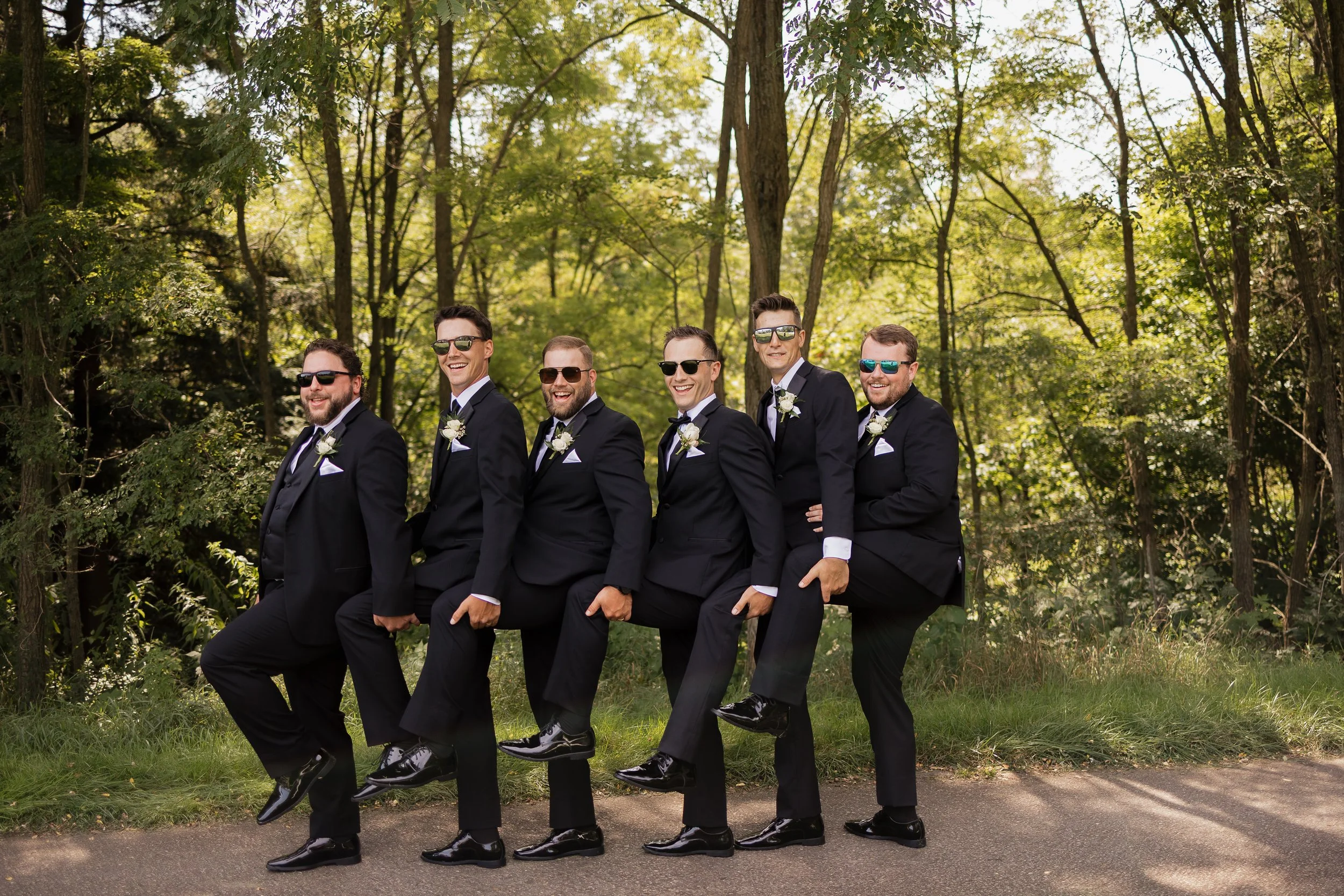 groom with groomsmen smiling and laughing, Ontario wedding photography by James and Alyson Photography