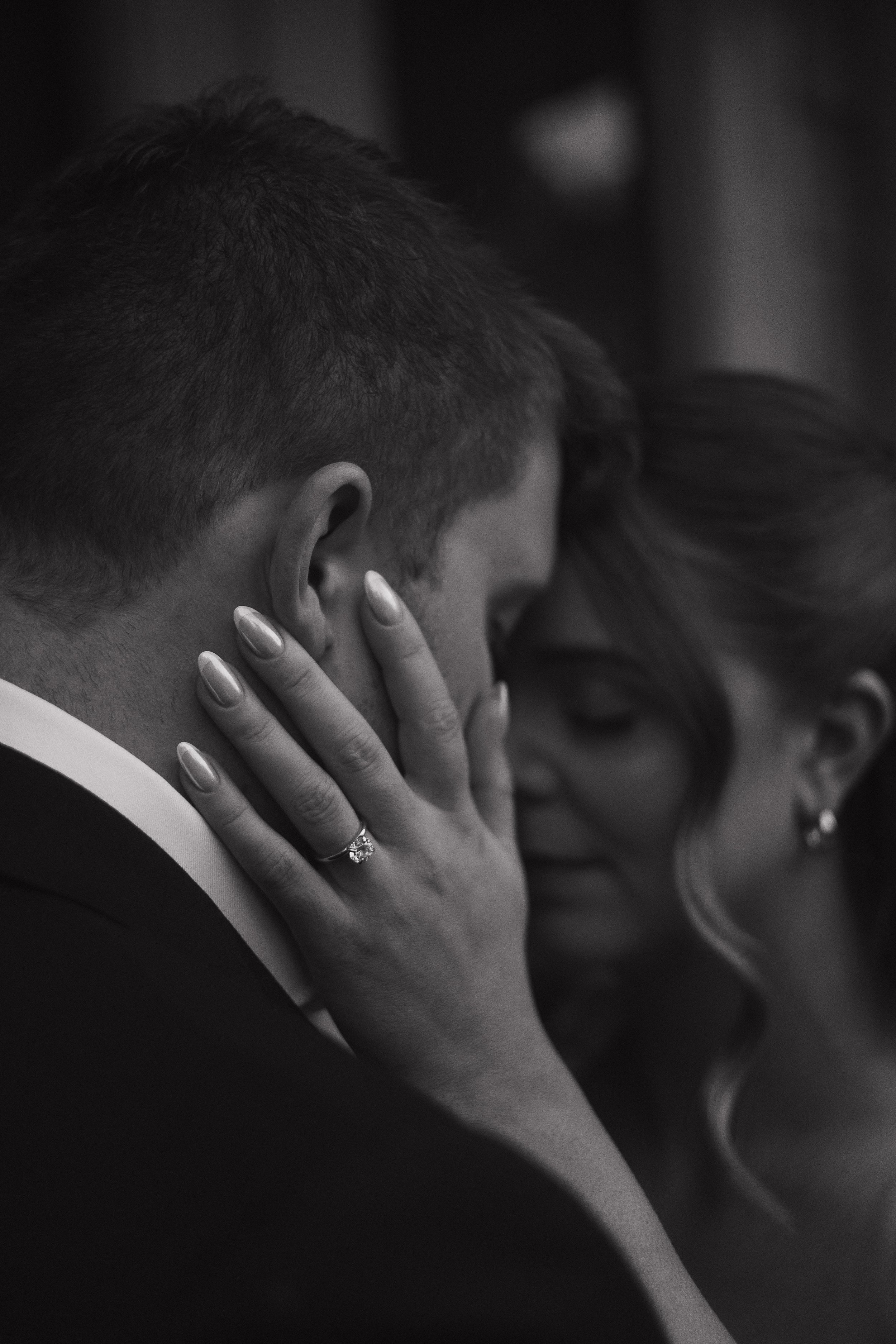 A soft and romantic embrace between an engaged couple in Hamilton Ontario