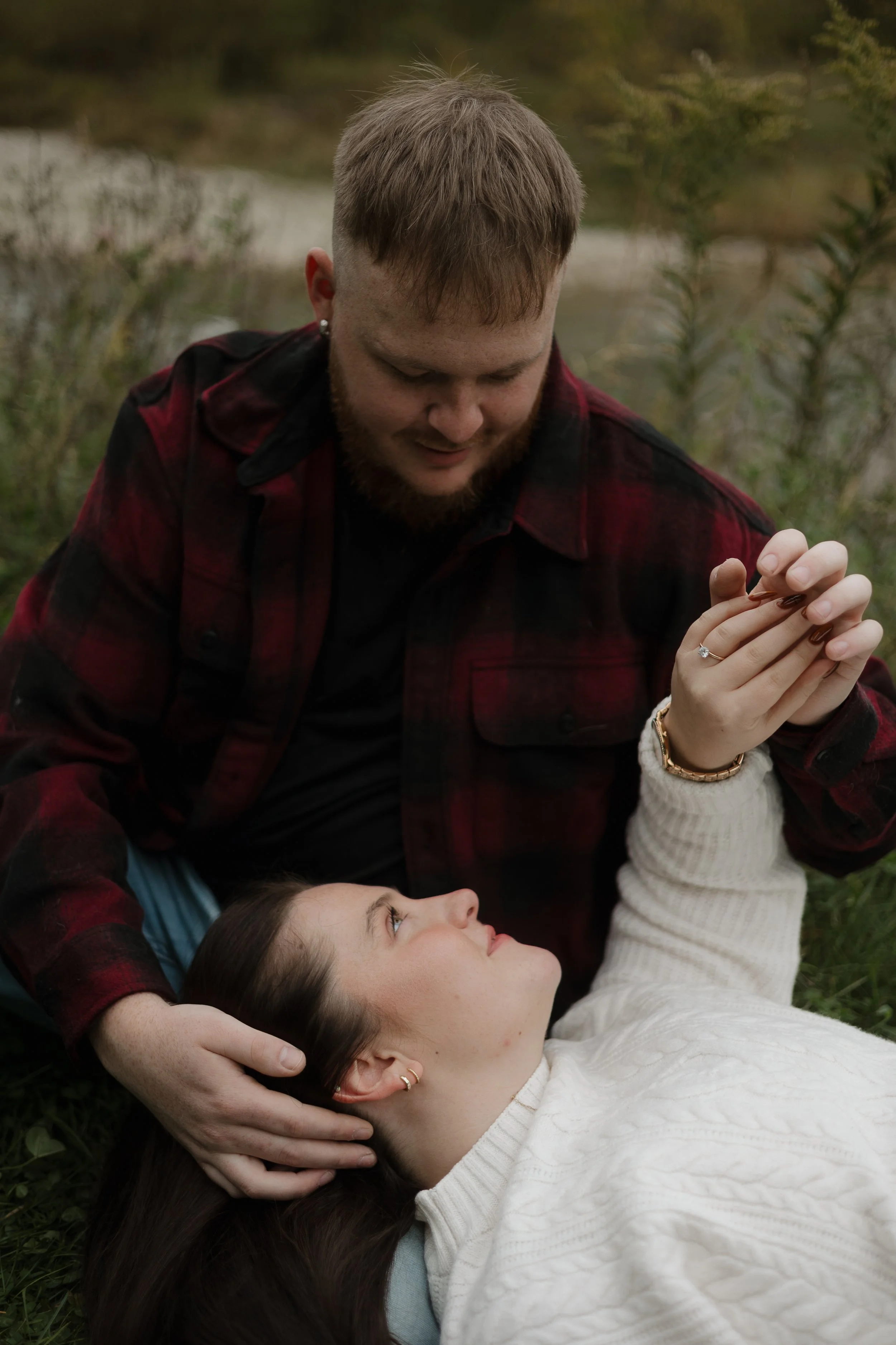 Engaged couple snuggled up at Penmans Pass in Paris Ontario