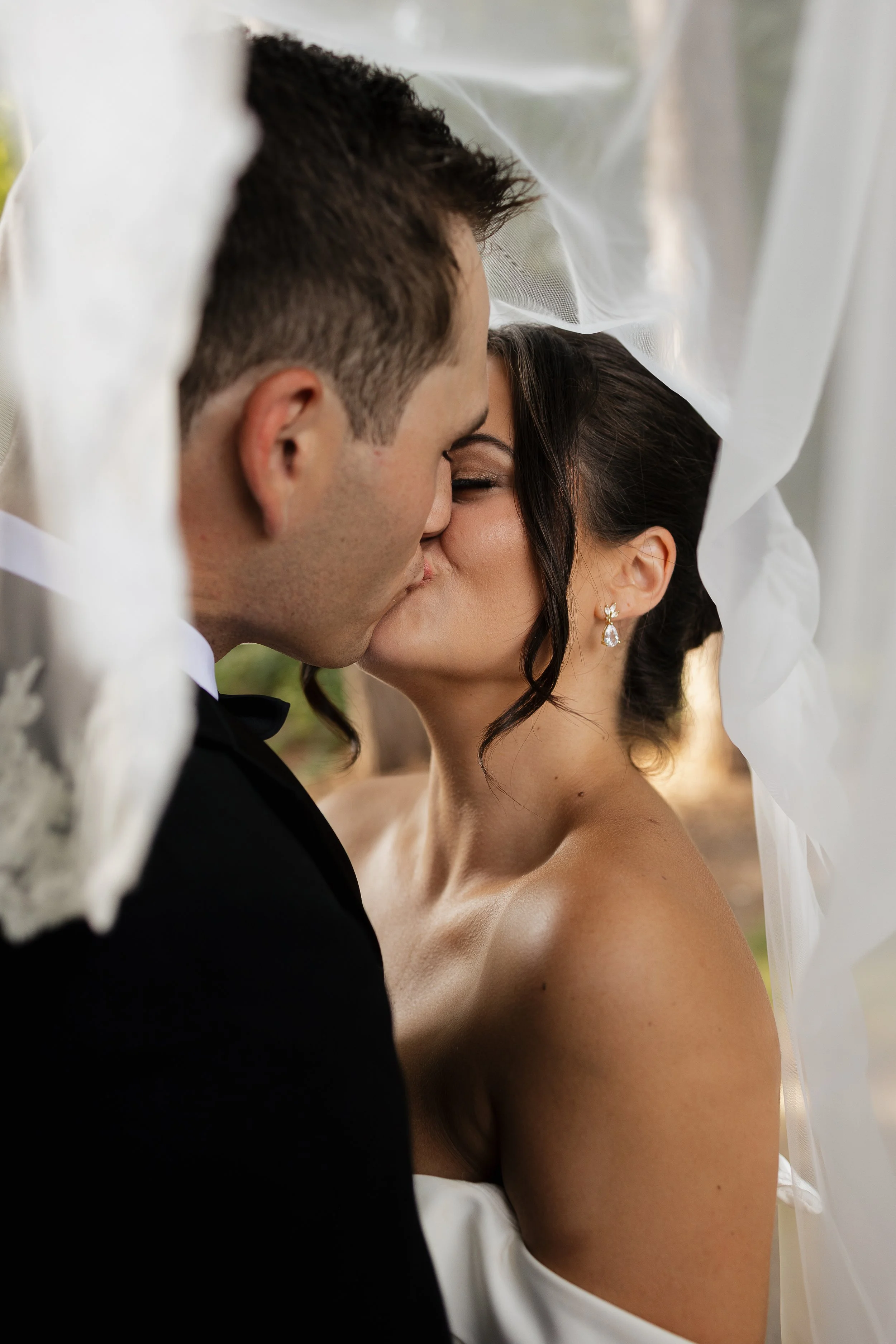 bride and groom kissing under the veil, ontario wedding photography by james and alyson photo