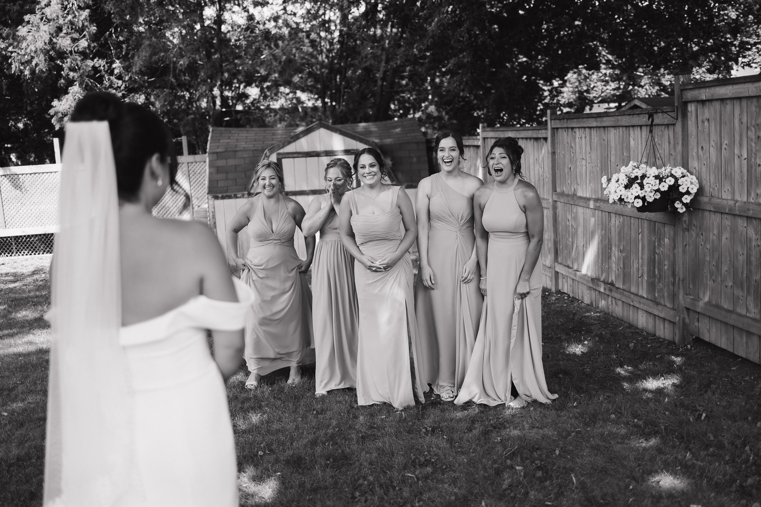 bride doing a first look with bridesmaids, Ontario wedding photography by James and Alyson Photography