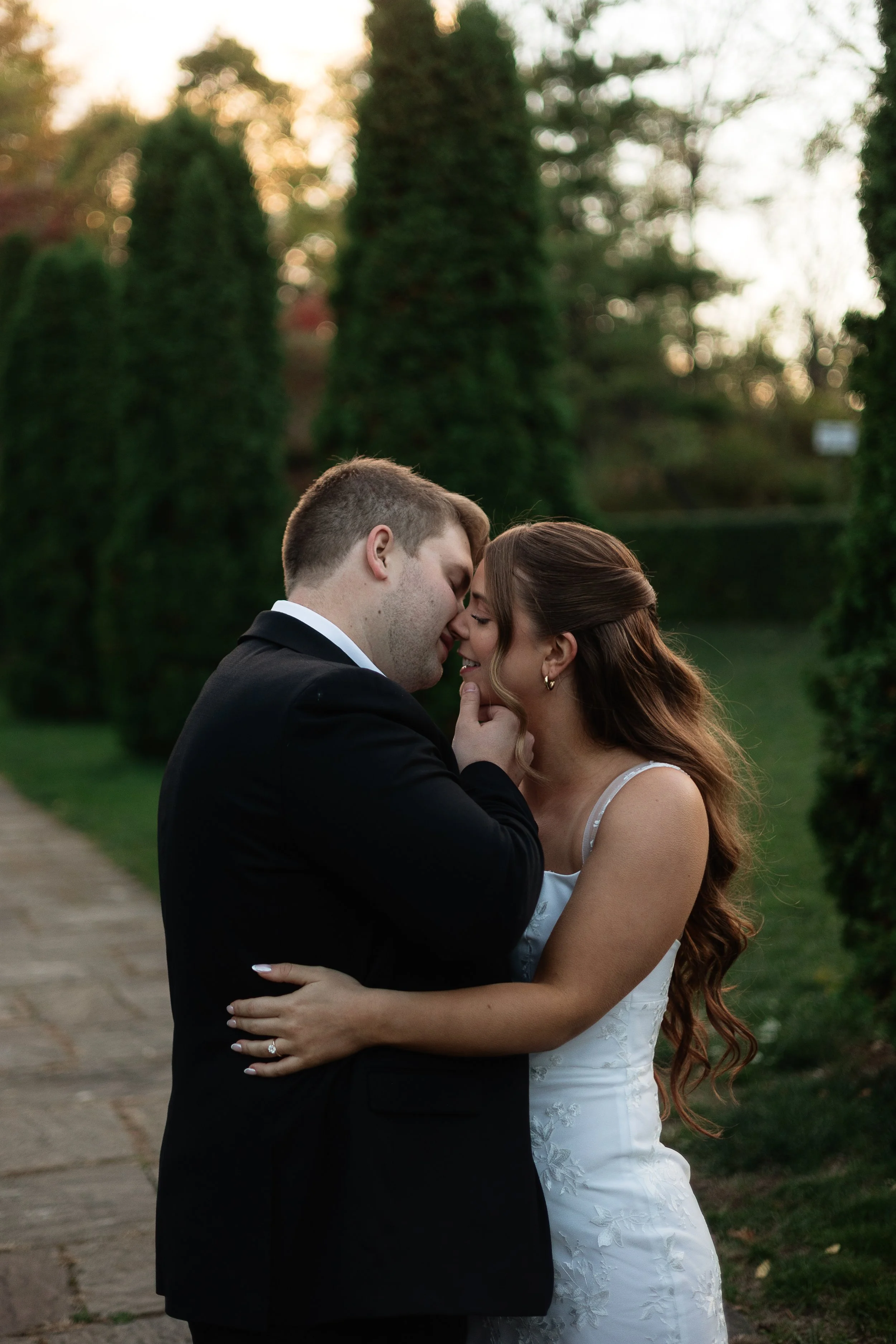 Couple embracing for a soft kiss, Ontario wedding photography by James and Alyson Photo