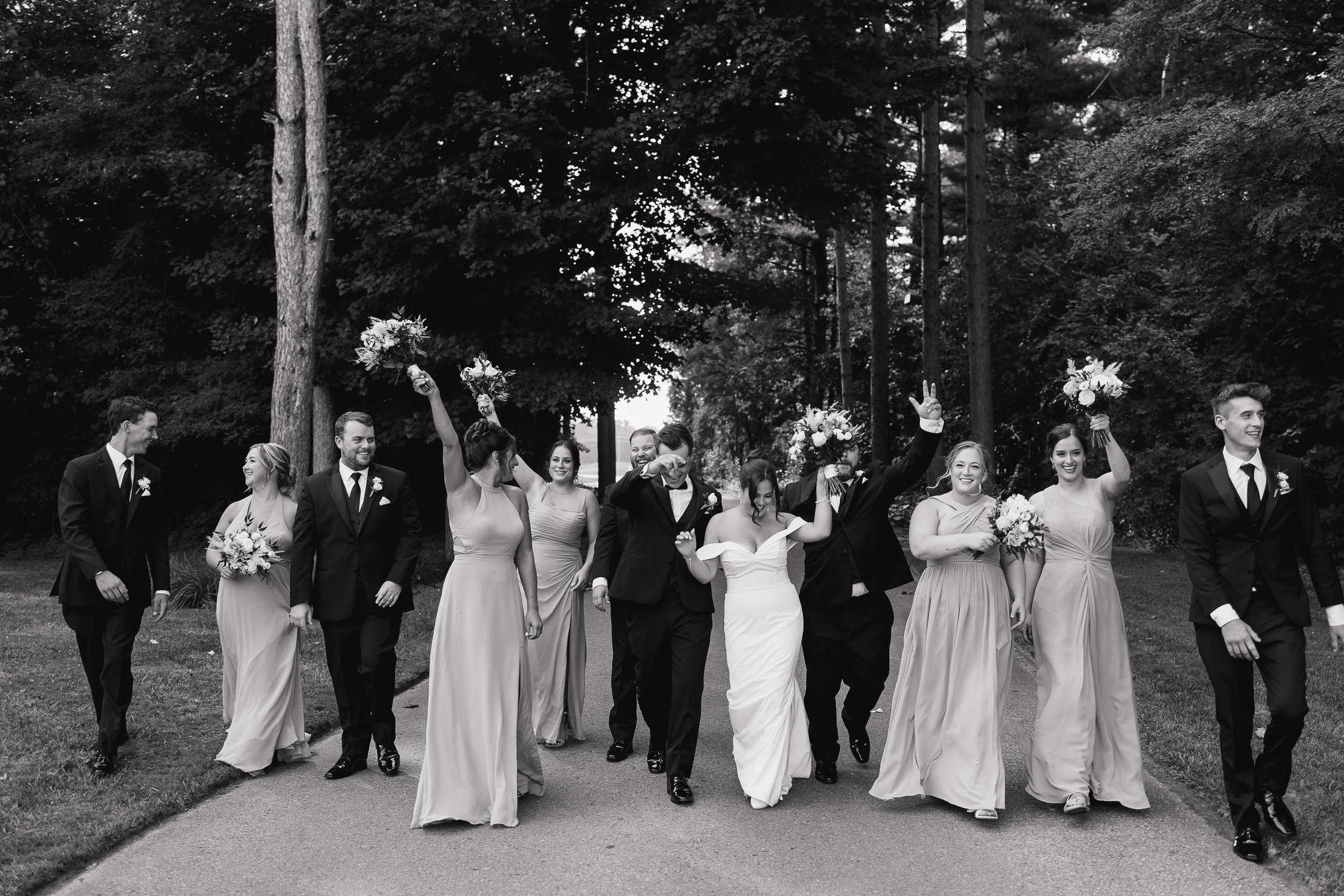 wedding party walking and laughing together, Ontario wedding photography by James and Alyson Photography