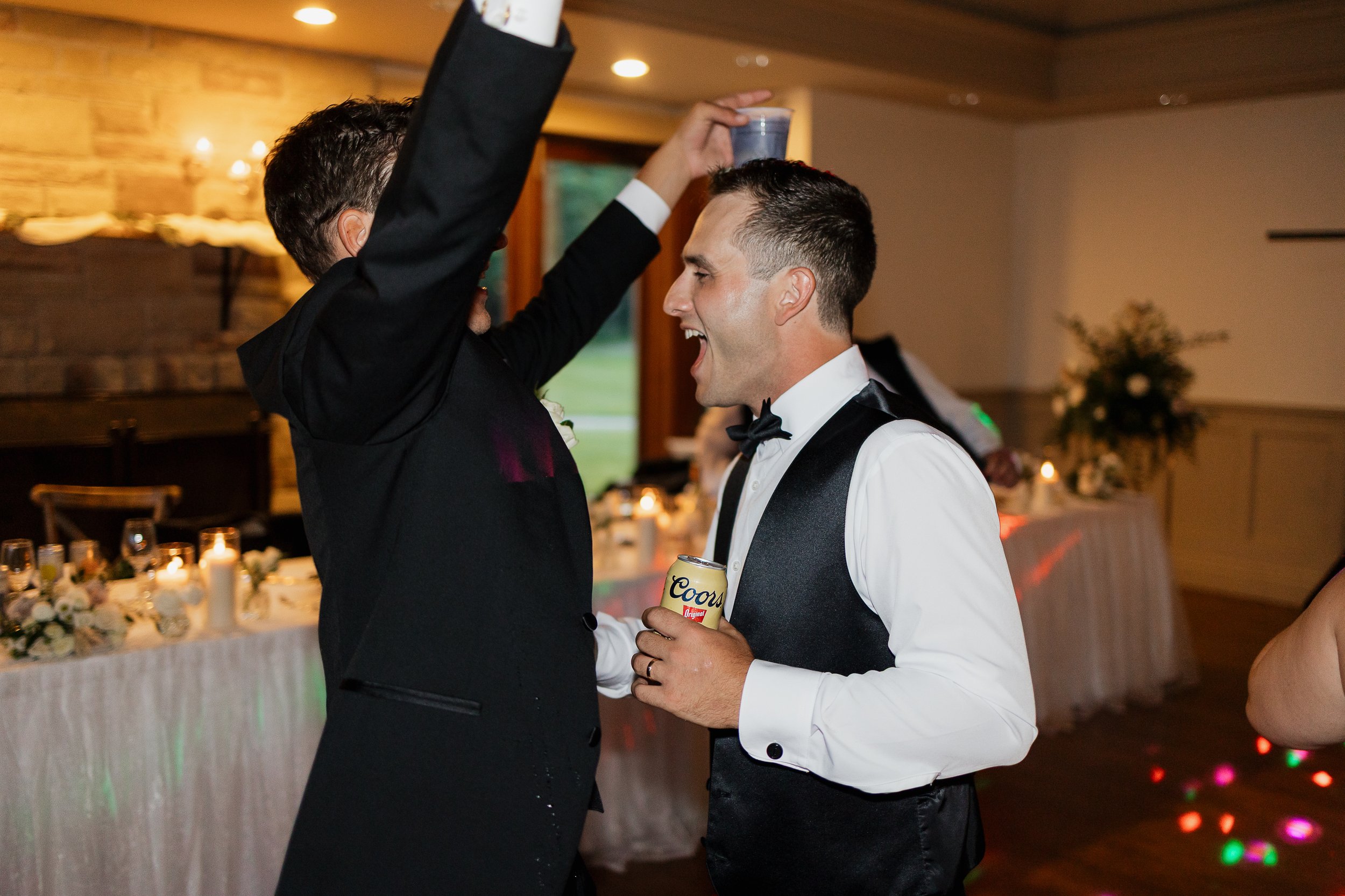 groom partying with friends on the dance floor, Ontario wedding photography by James and Alyson Photography
