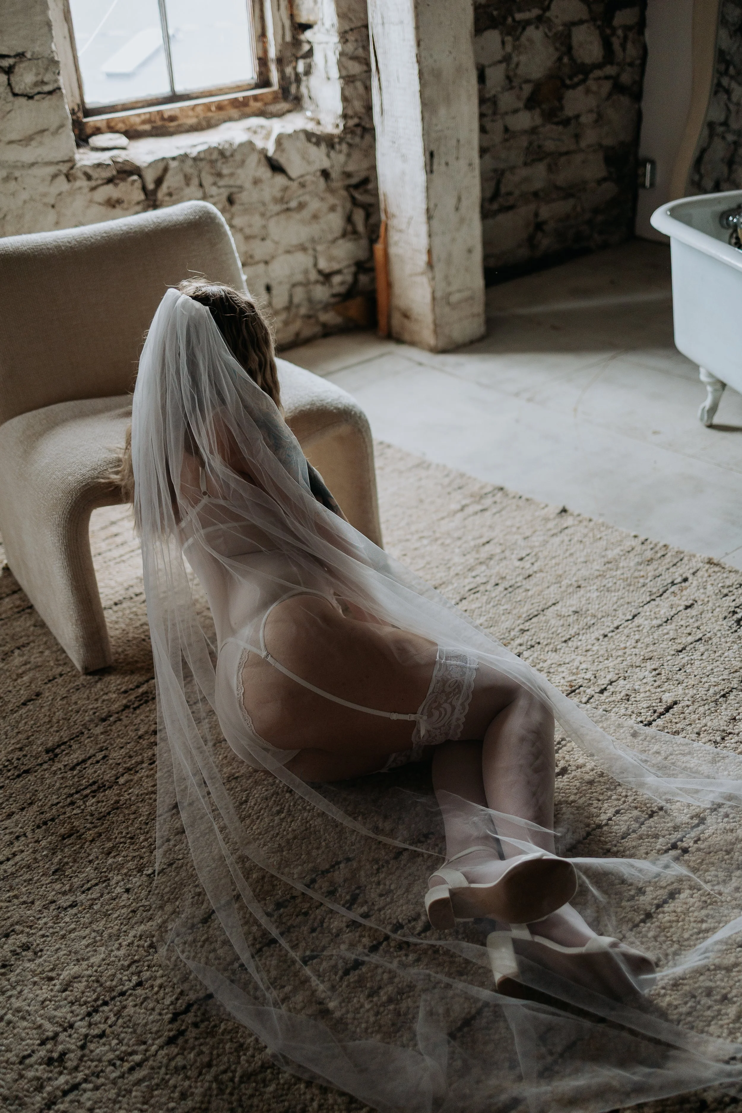 Bridal boudoir photography in Brantford featuring a bride in elegant lingerie for an intimate portrait session.