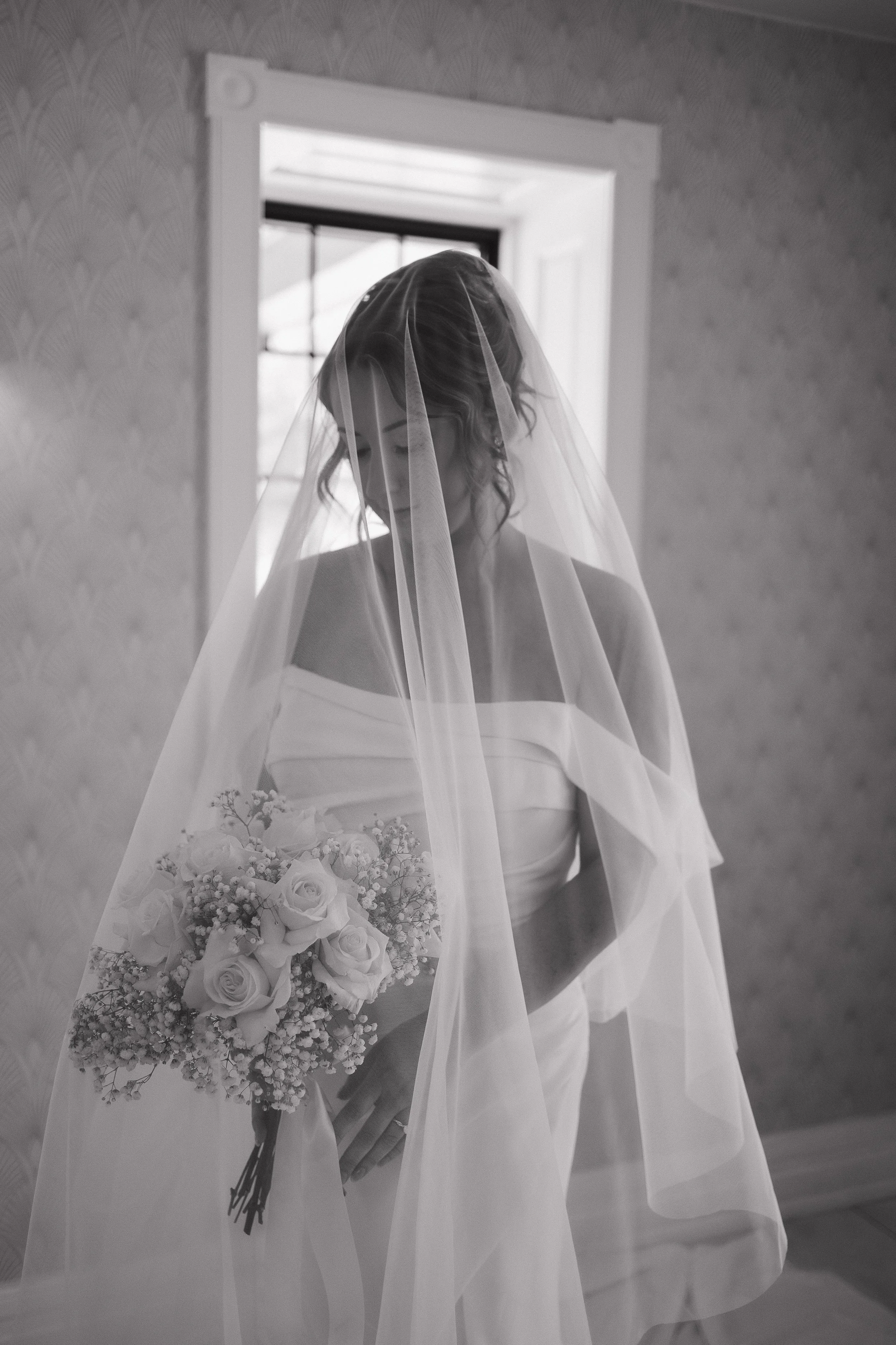 Bride under her veil holding her bouquet, Cellar 52 St. Jacobs wedding, Ontario wedding photography by James and Alyson Photography