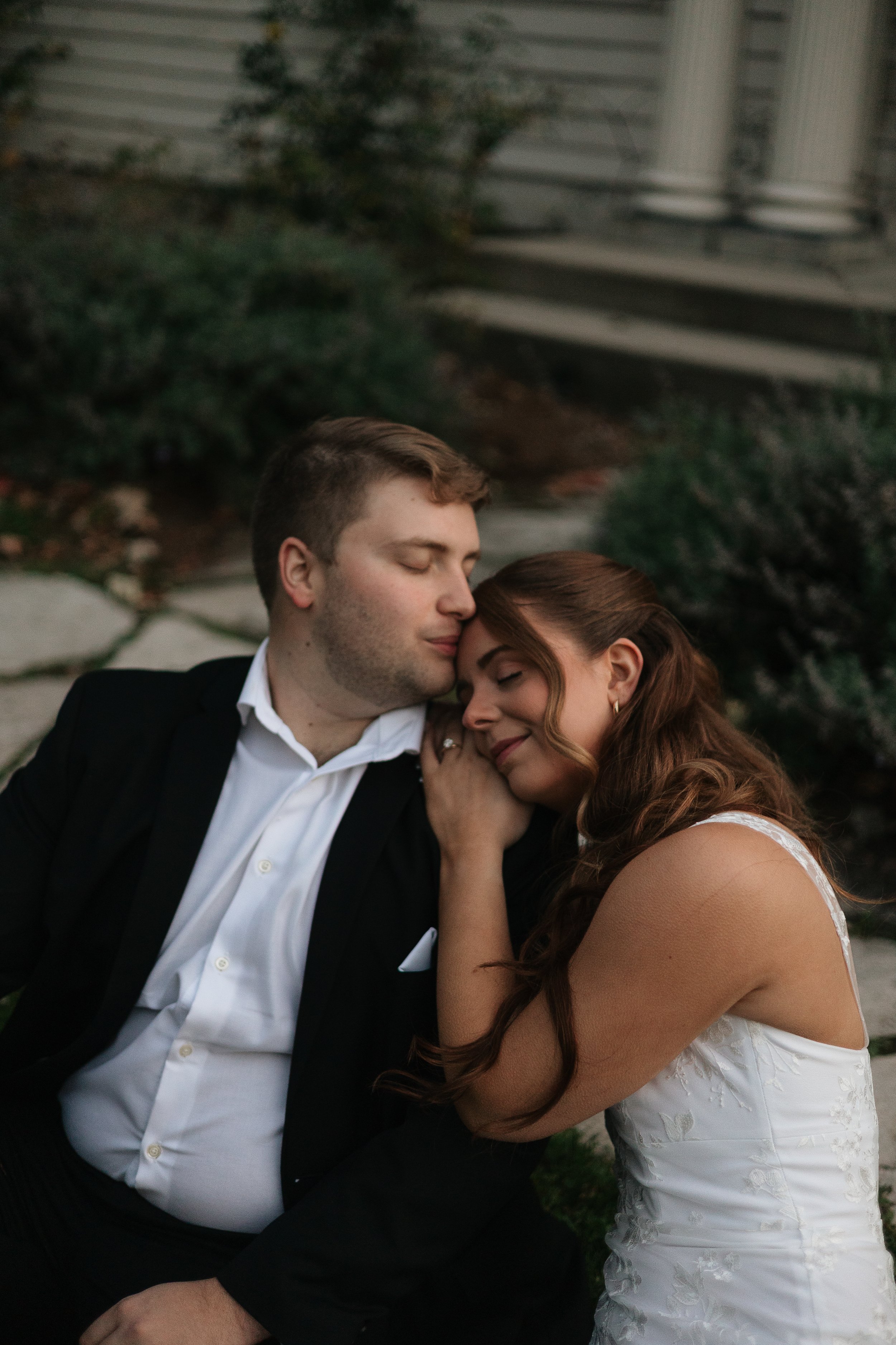 Engaged couple cuddling at engagement shoot in Hamilton Ontario