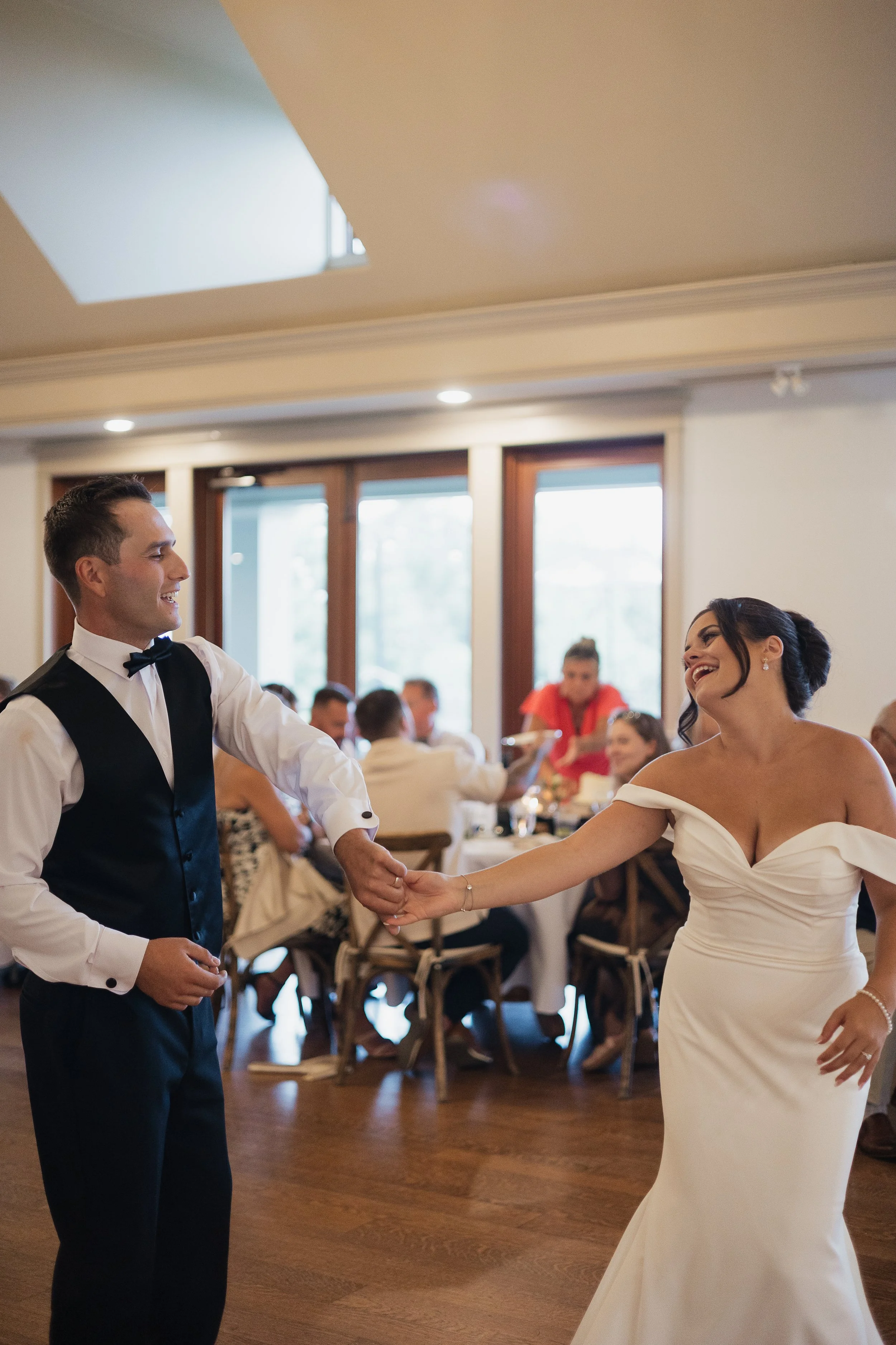 bride and groom laughing together during first dance, Ontario wedding photography by James and Alyson Photography