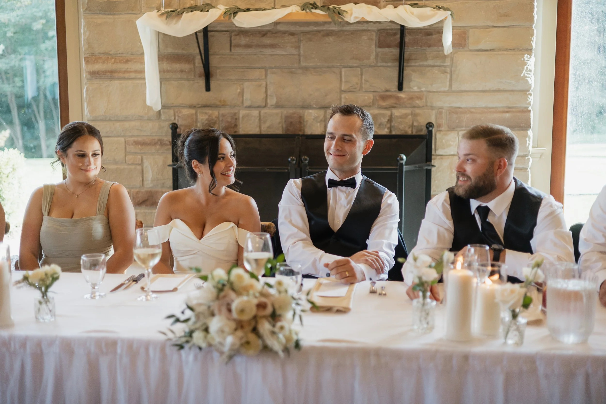 bride and groom laughing during speeches, Ontario wedding photography by James and Alyson Photography