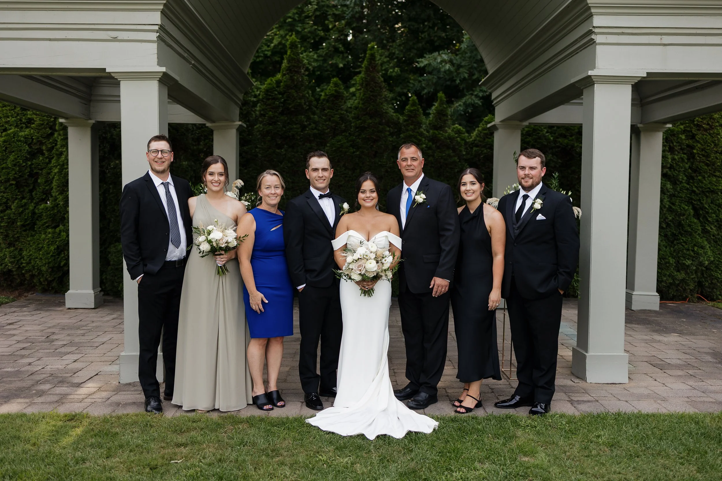 bride and groom portrait with grooms family, Ontario wedding photography by James and Alyson Photography