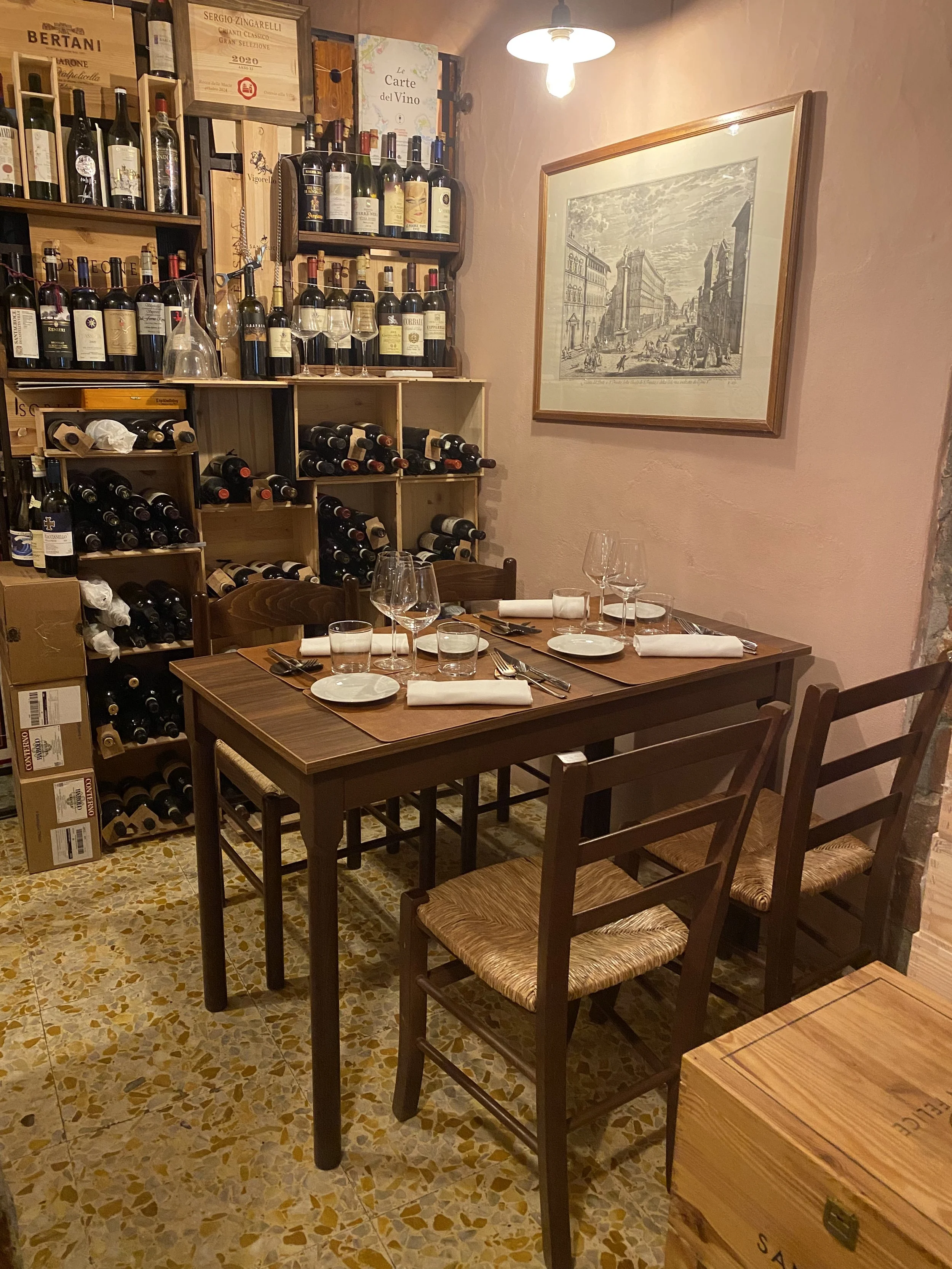 A cozy Tuscan restaurant corner with a wooden table set for four. Modern, yet authentic Tuscany ambiance for the perfect dining experience in Siena, Castelnuovo Berardenga, Villa A Sesta.