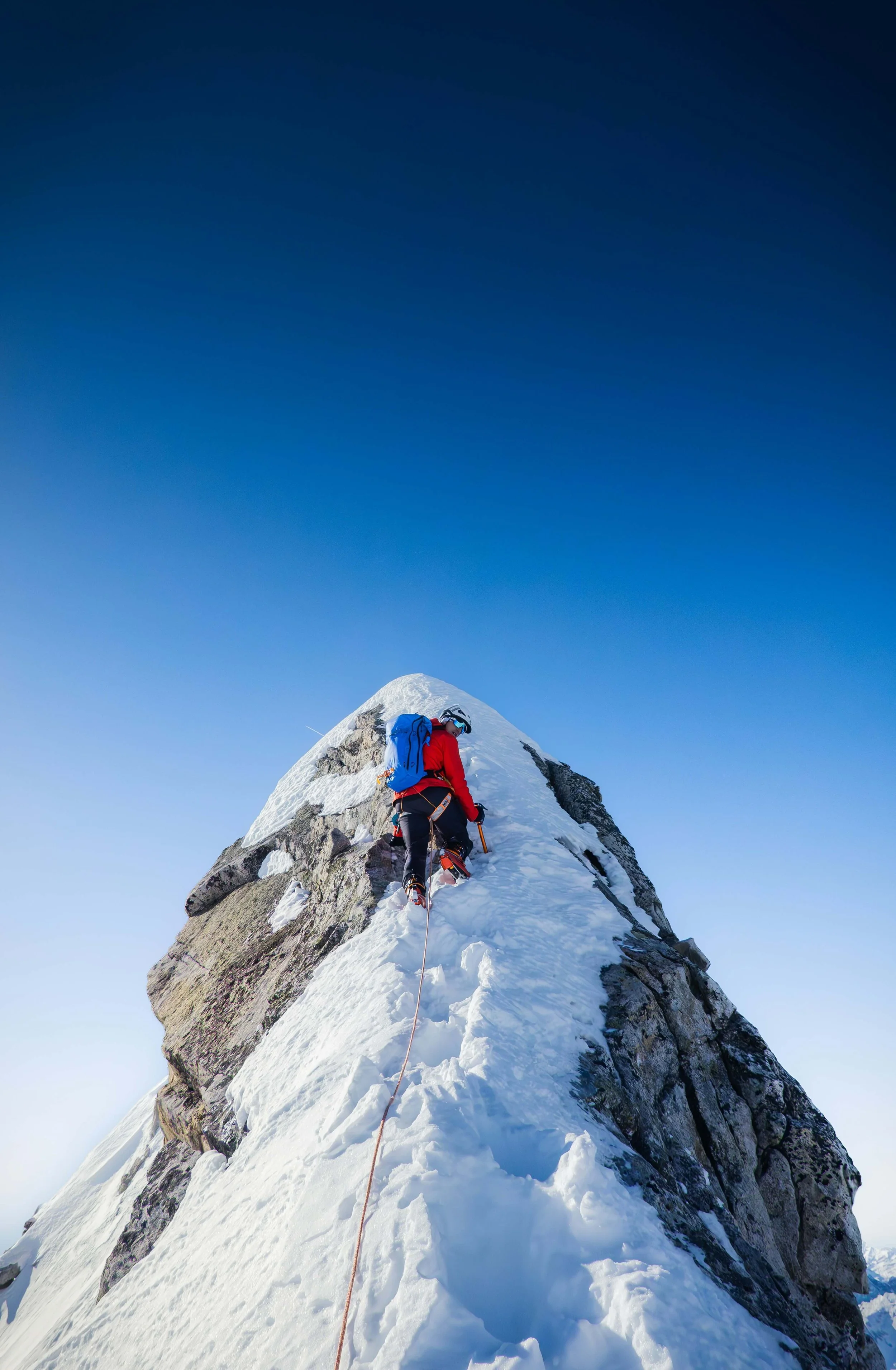 climber on summit of mountain