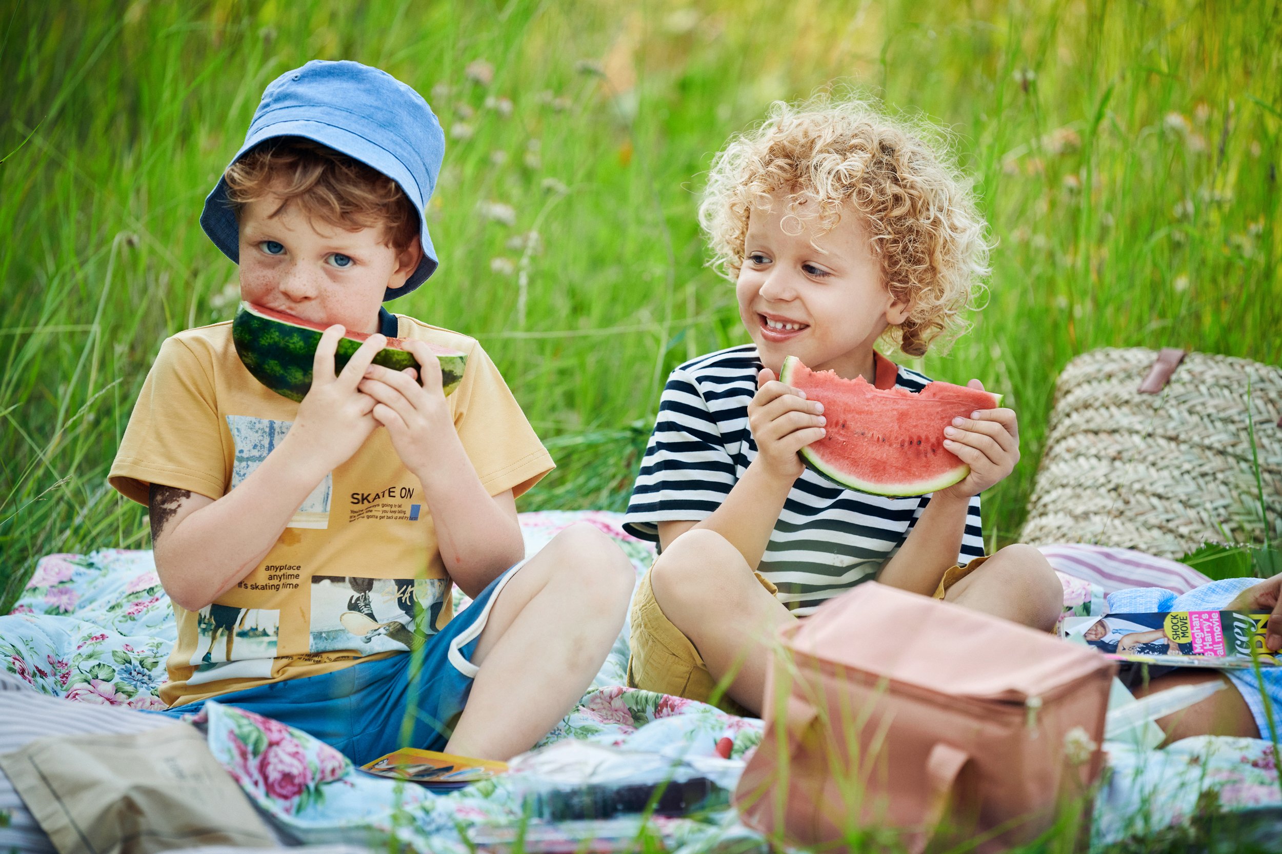 Children eating watermelon outdoors, everyday food moment