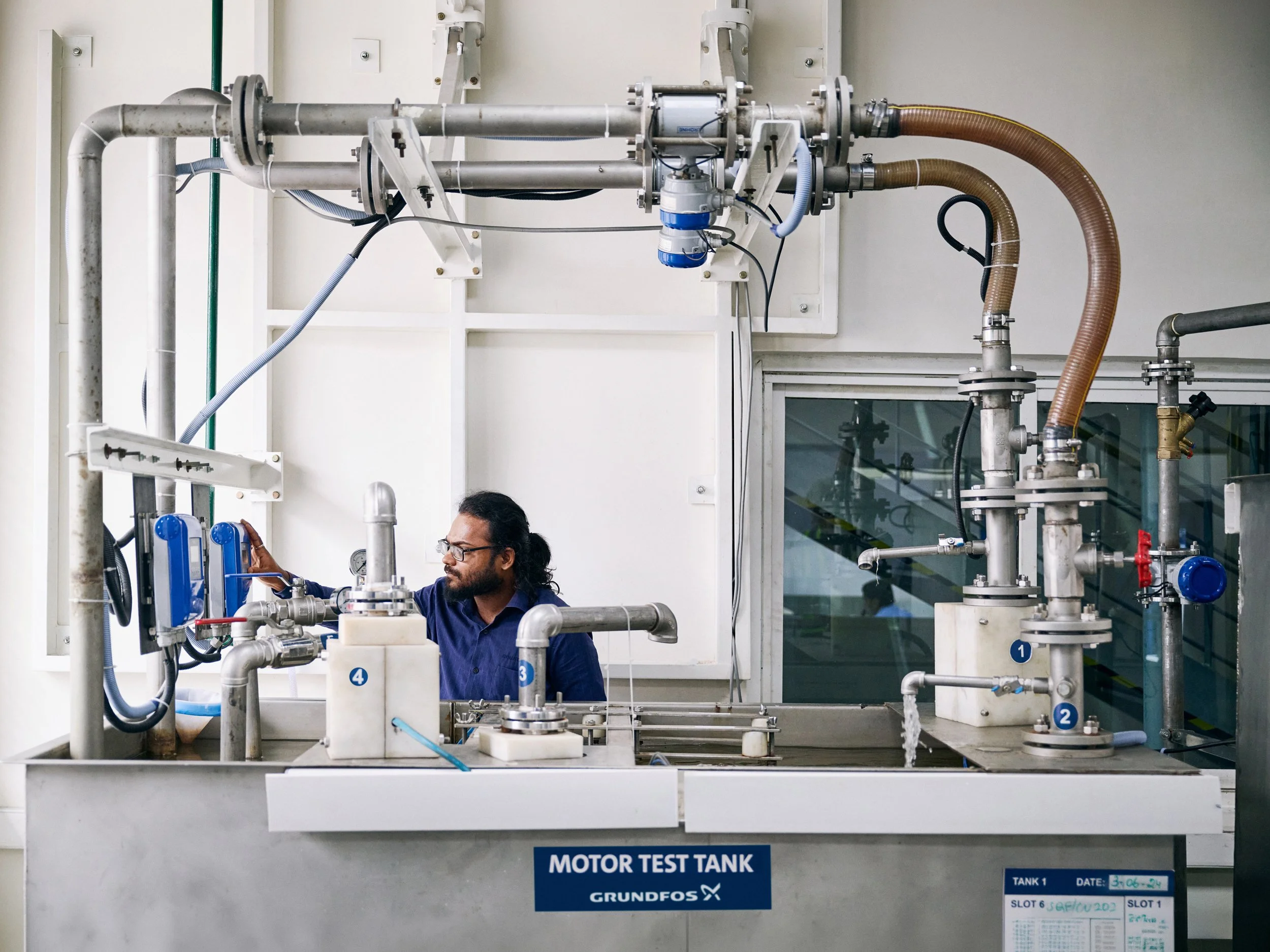 Researcher operating large testing tank in laboratory environment