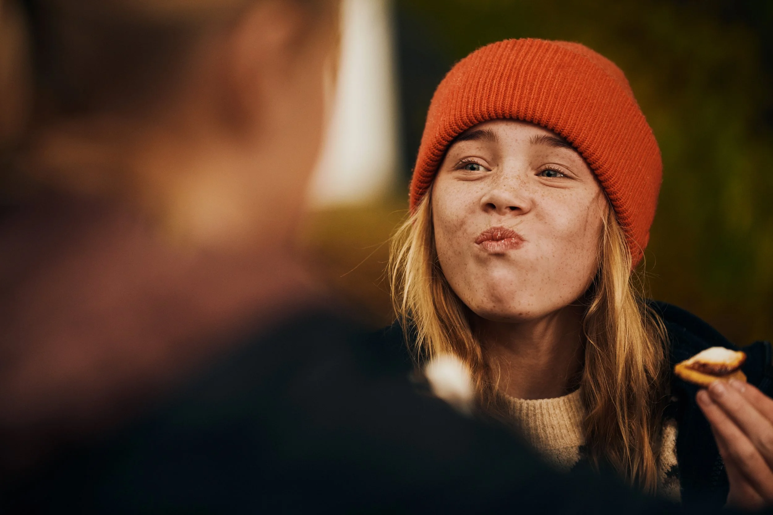 Girl eating marshmallows outside, autumn outdoor moment