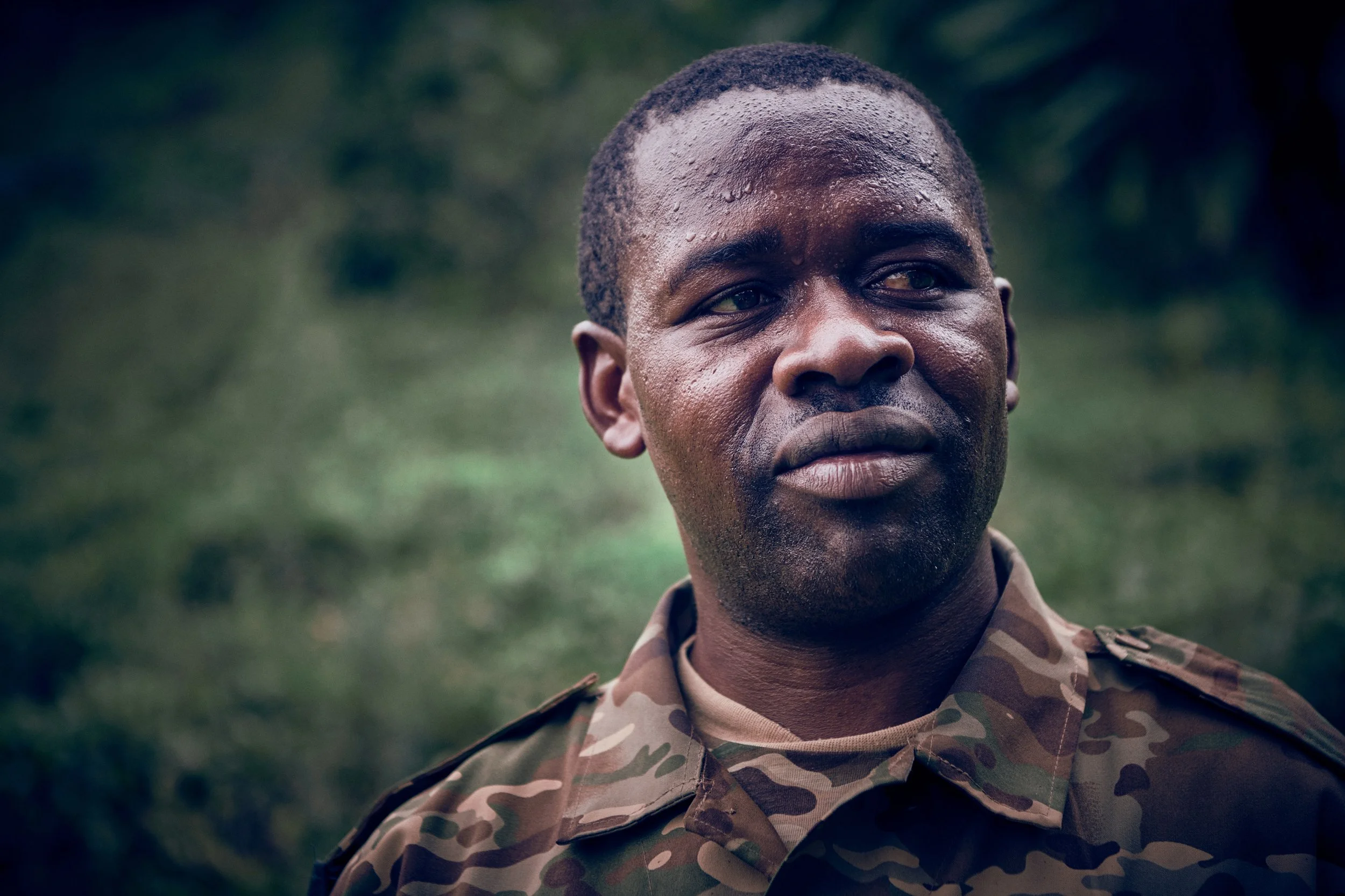 Portrait of ranger in uniform, focused expression in natural surroundings