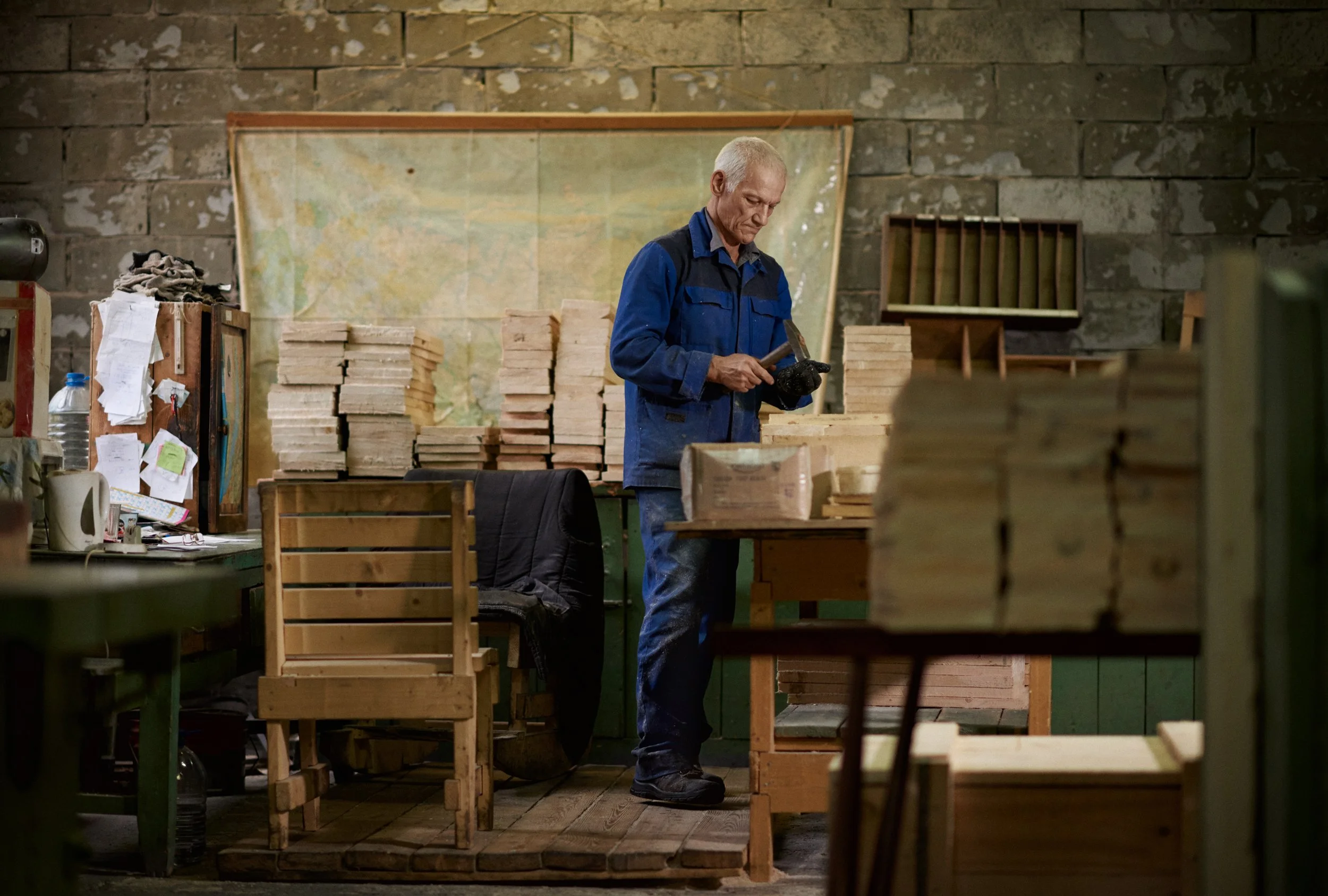 Older man working alone in workshop, hands-on task and craft setting