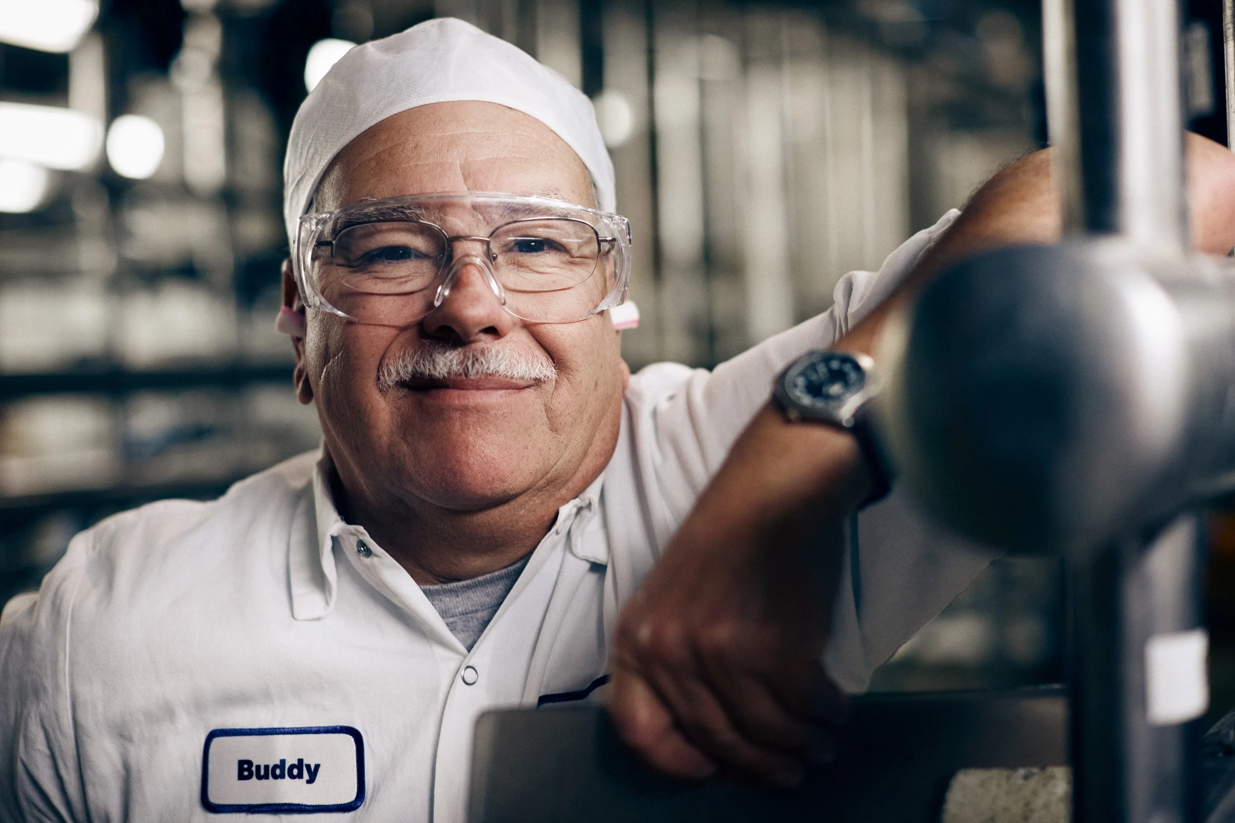 worker portrait in production facility, biosolutions manufacturing environment