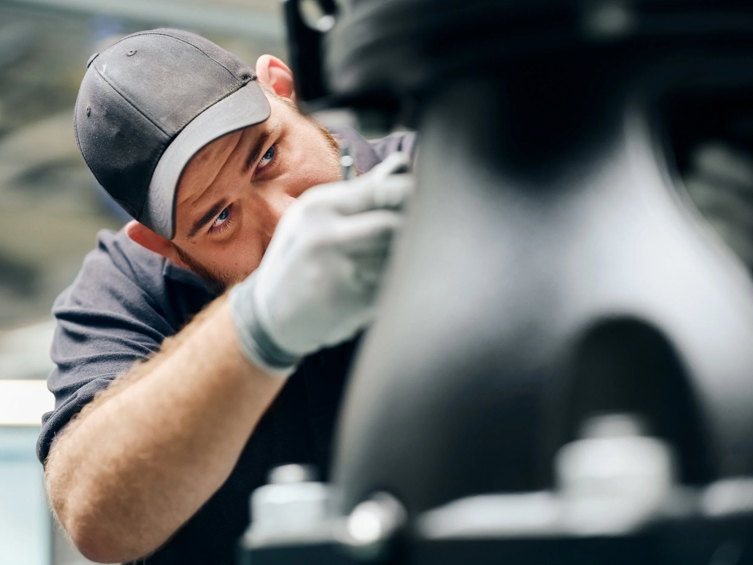Technician working on a  pump unit, focused expression on his face