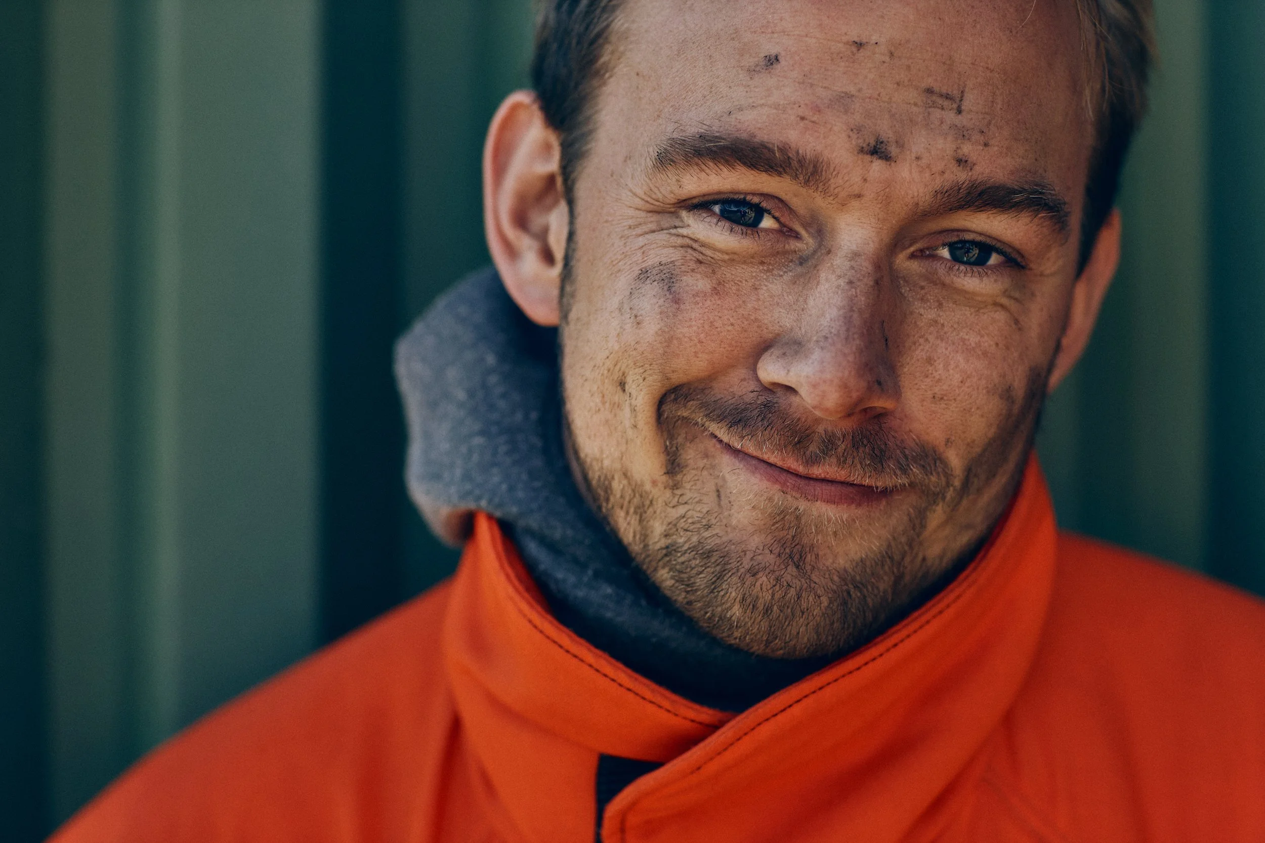 Portrait of firefighter with soot on face, natural expression after operation