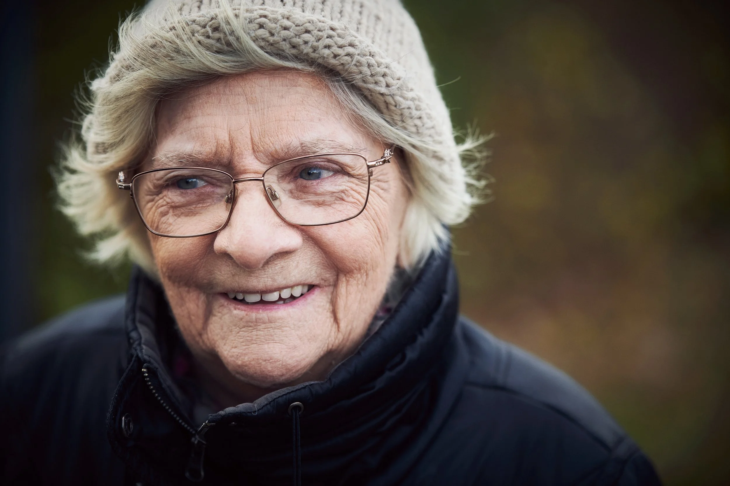 Portrait of elderly woman outdoors, natural expression in soft light