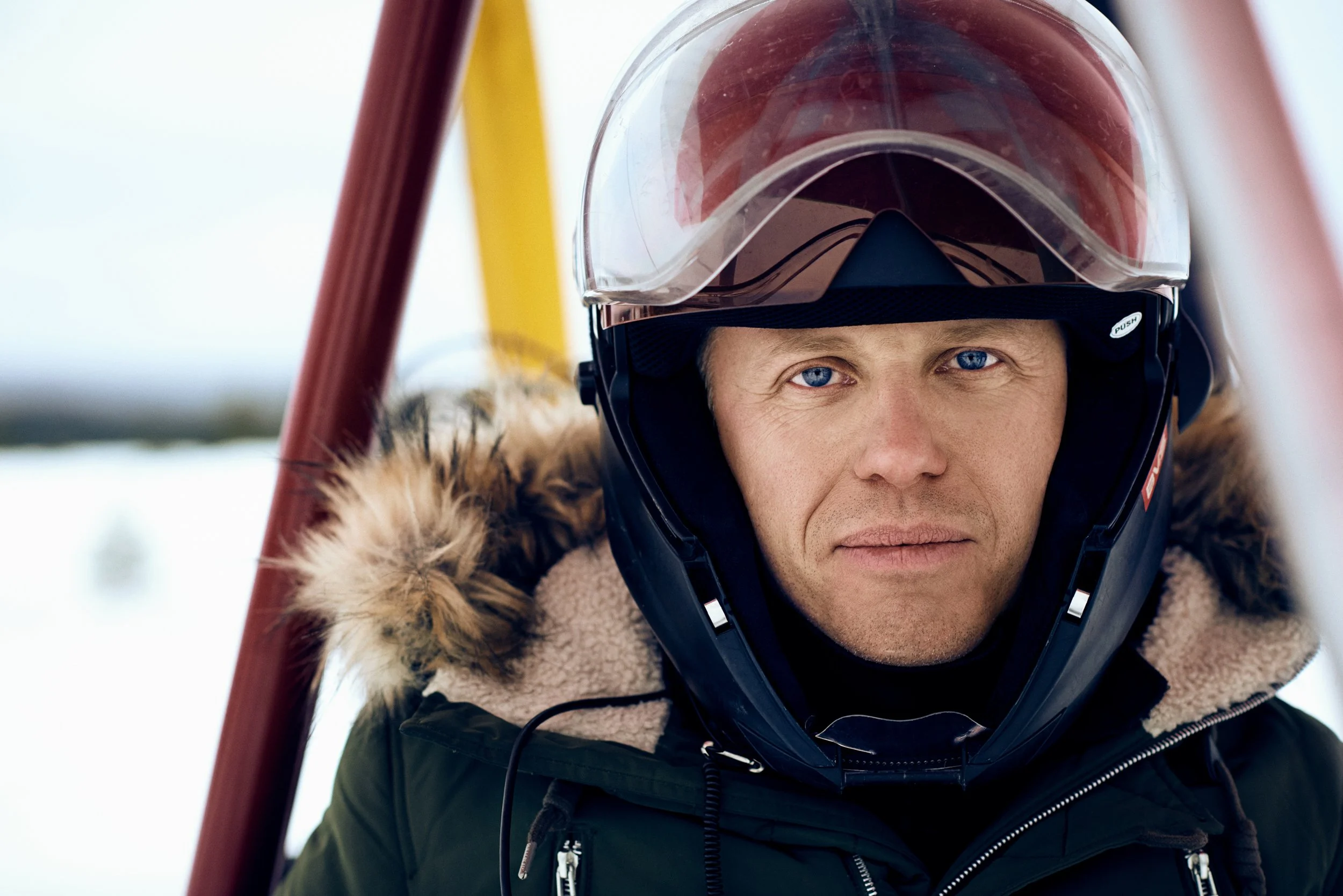 Portrait of man wearing helmet in snowy environment, direct gaze