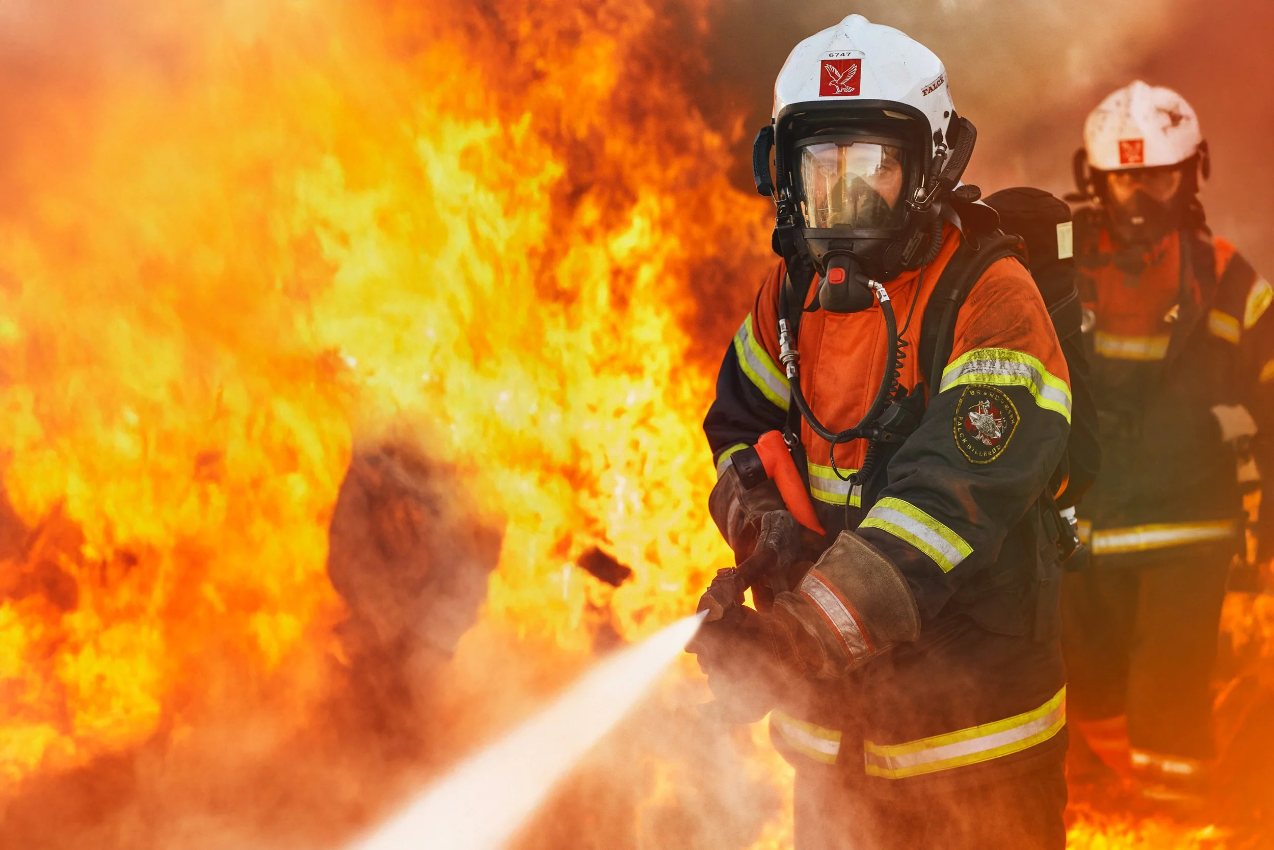 Firefighters extinguishing flames during active fire response, high-intensity rescue operation