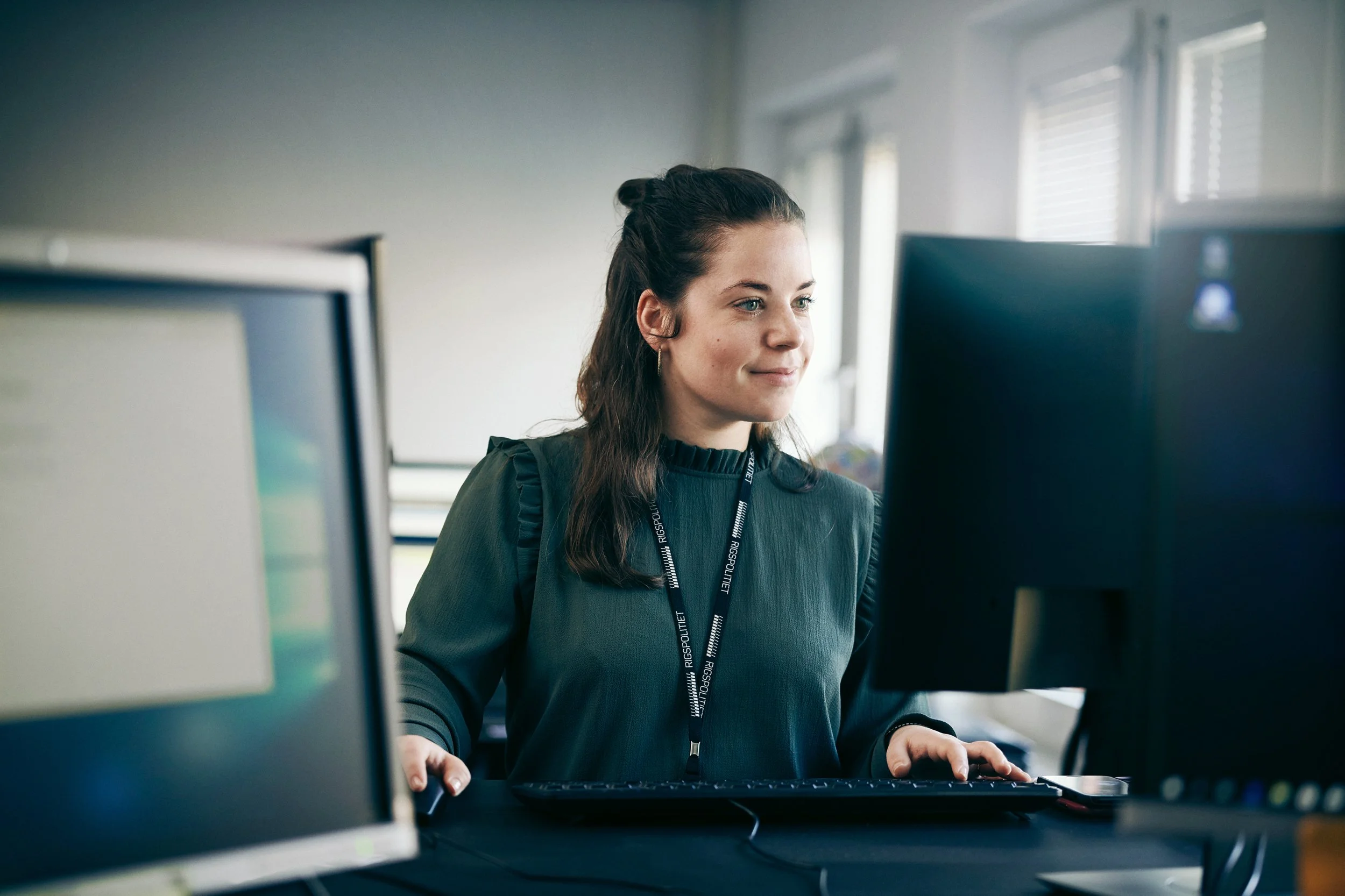 Woman working at computer workstation in office