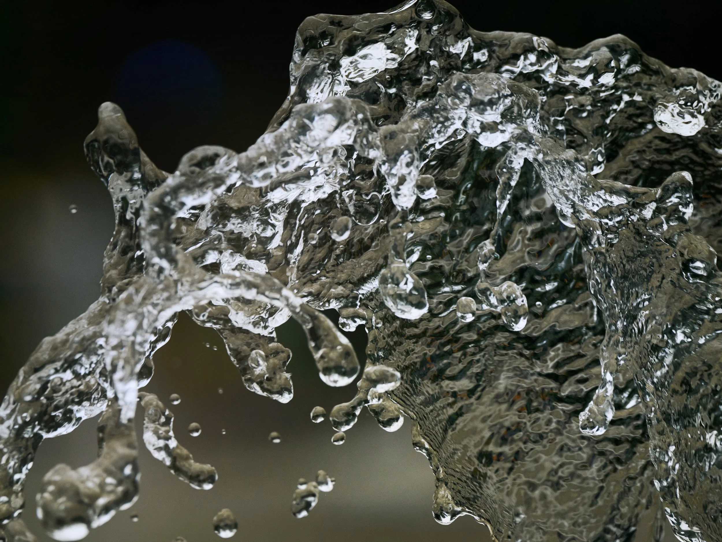 Close-up of flowing water captured in motion, detailed texture and droplets in mid-air