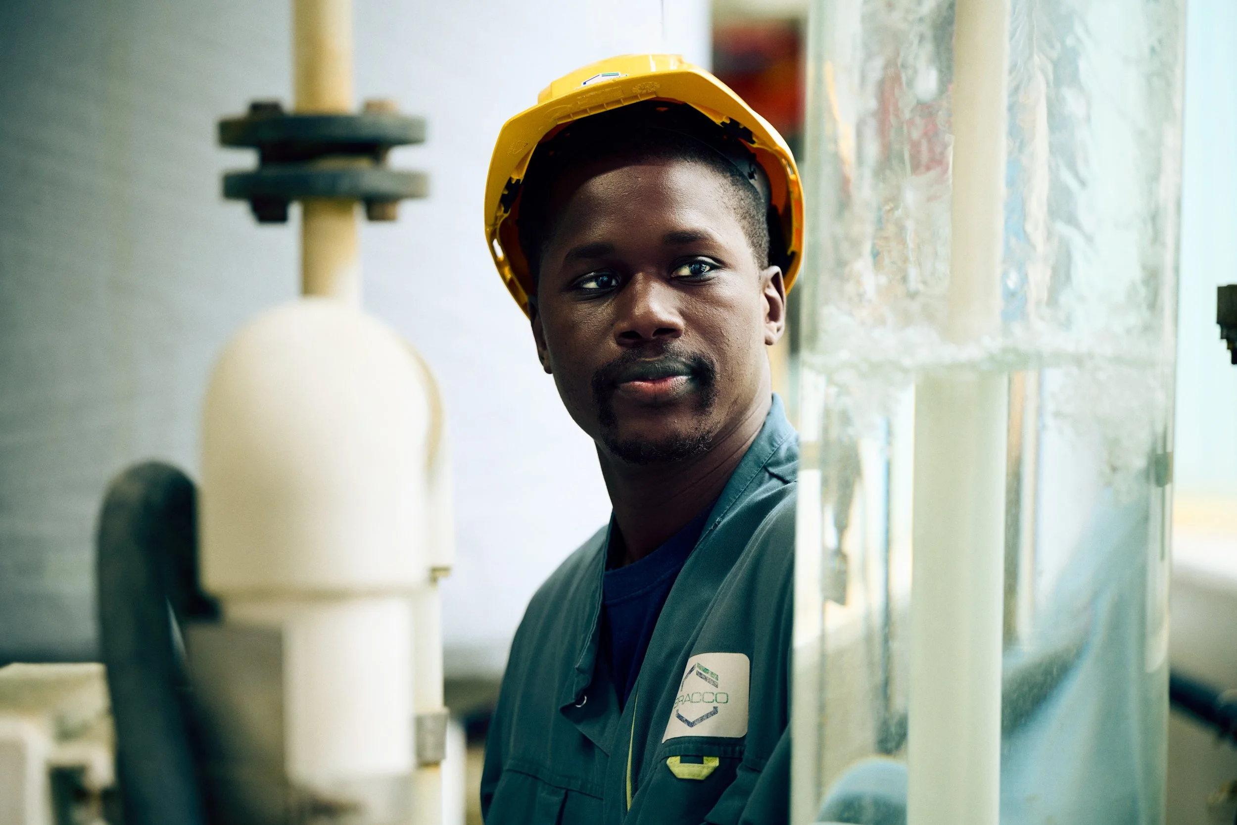 Technician moving through industrial environment, navigating between systems and structures