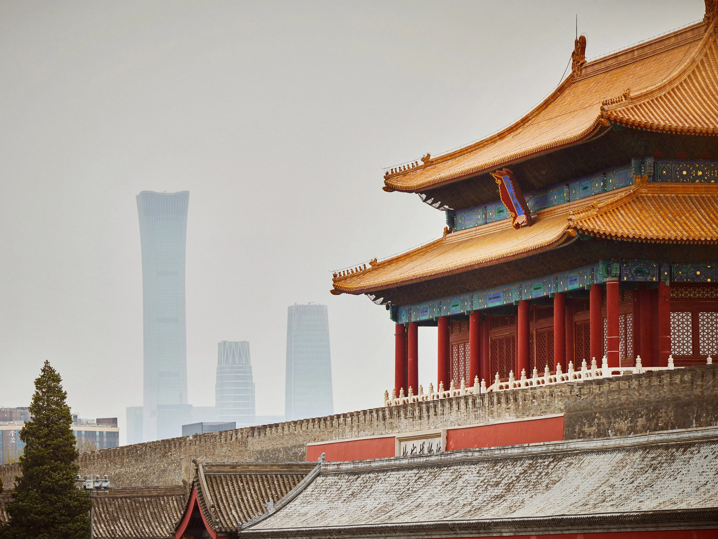 Traditional Chinese building with modern city skyline in background