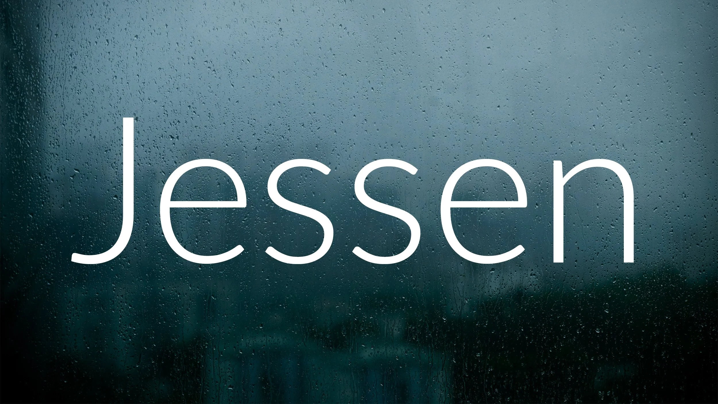 Rain-covered window with the word 'Jessen' written across in white text.