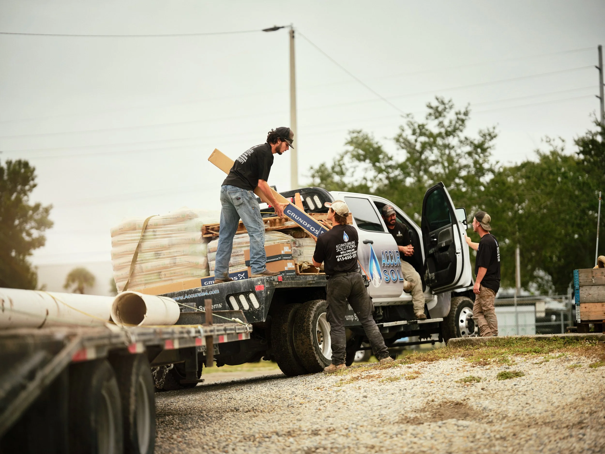 Crew unloading materials from truck at work site