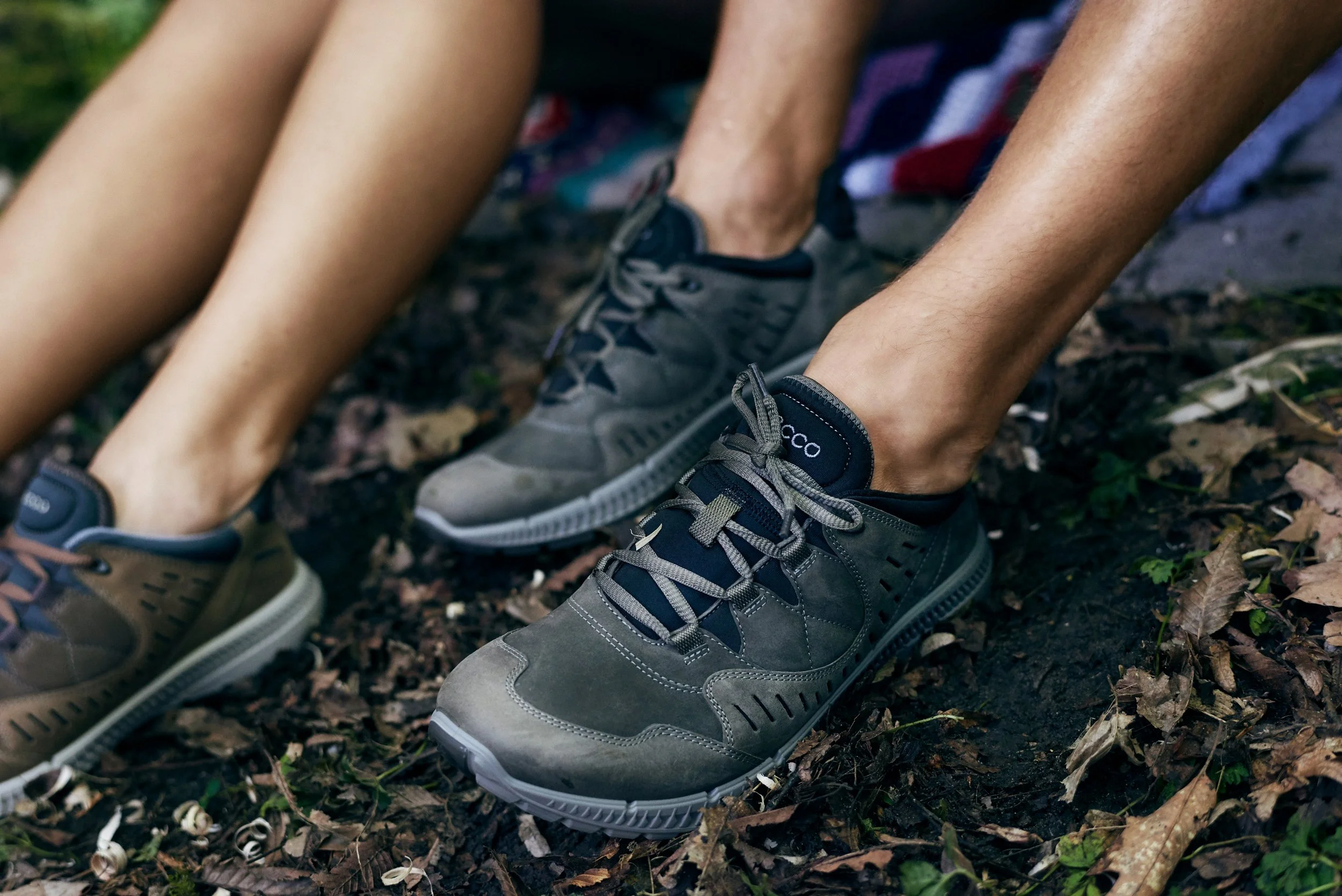 Close-up of outdoor shoes on forest ground, worn in natural terrain