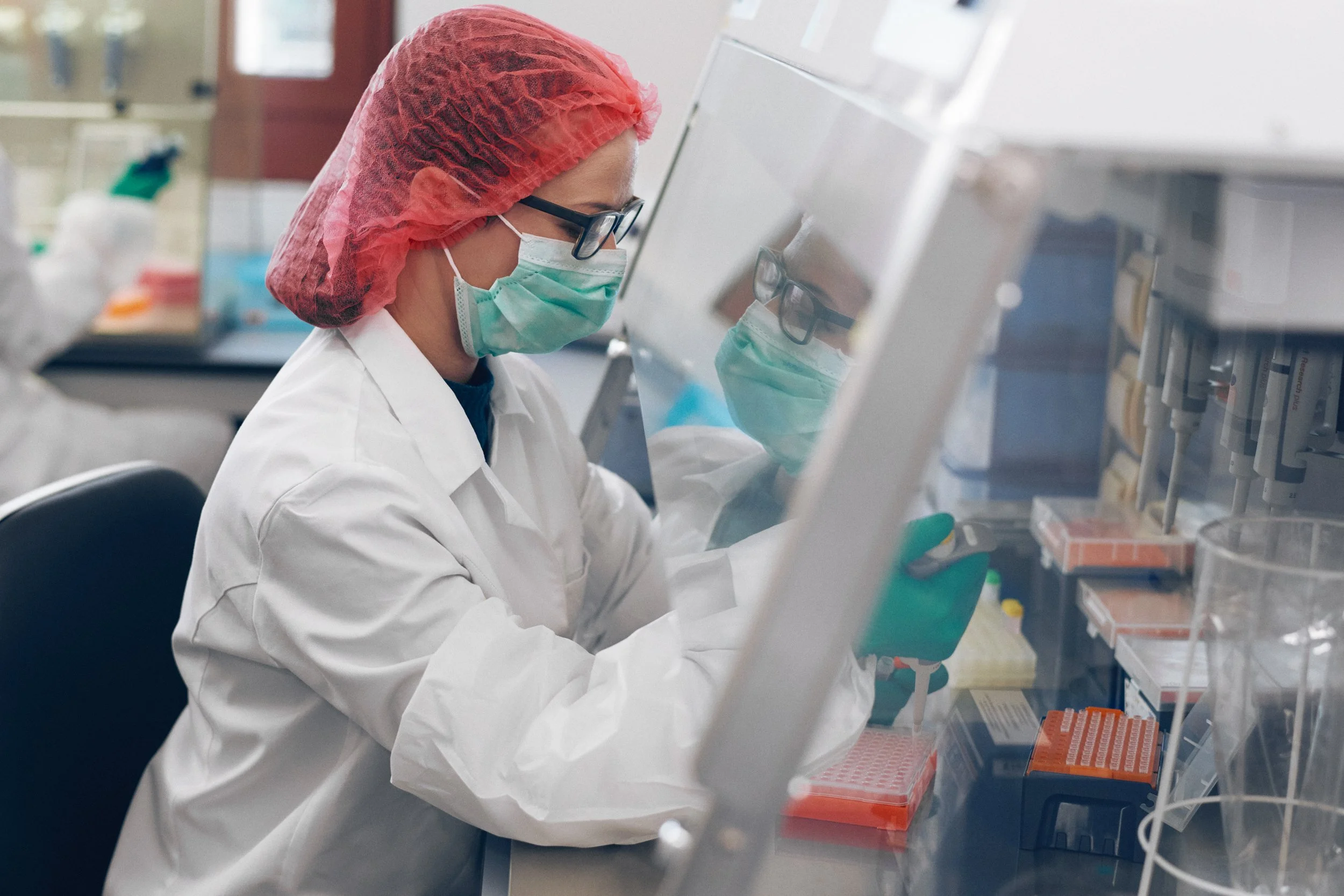 Technician performing pipetting task with precision, part of laboratory analysis workflow