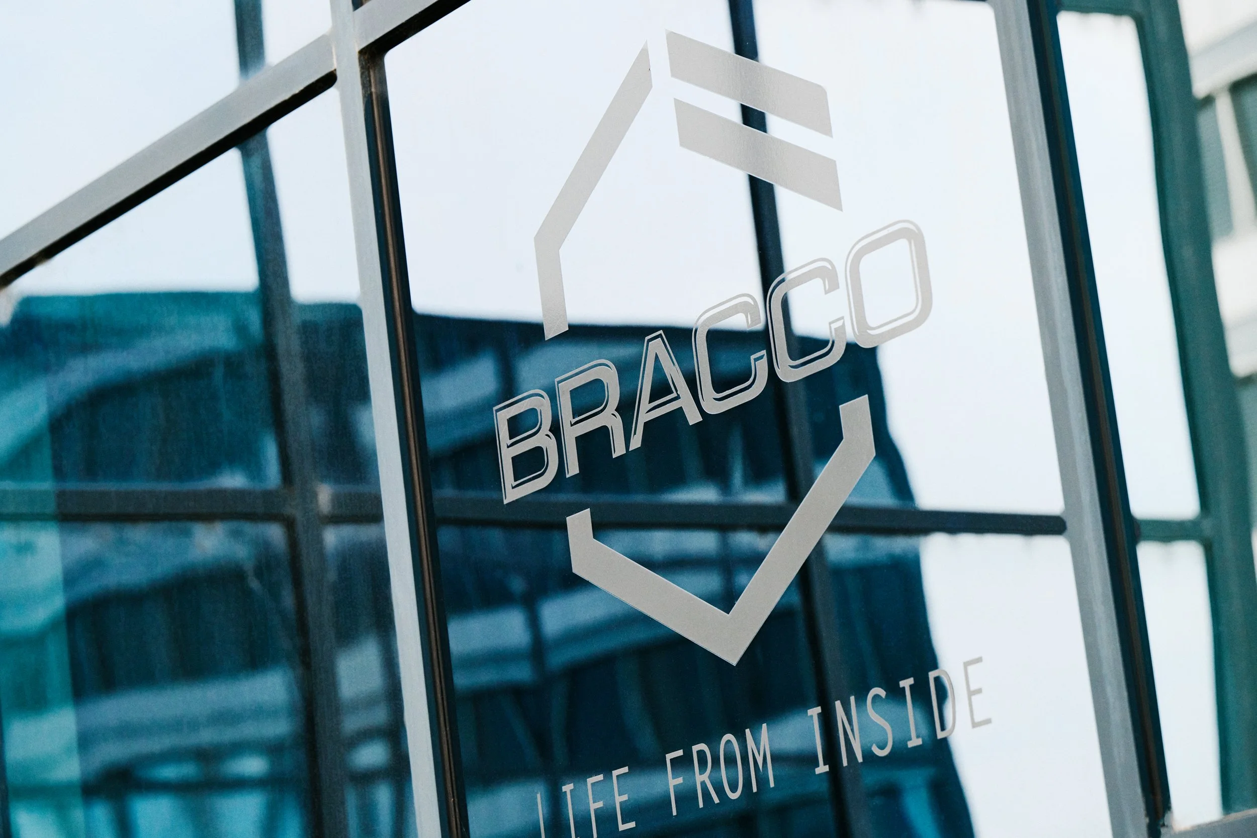 Bracco logo on glass facade, exterior branding and corporate identity
