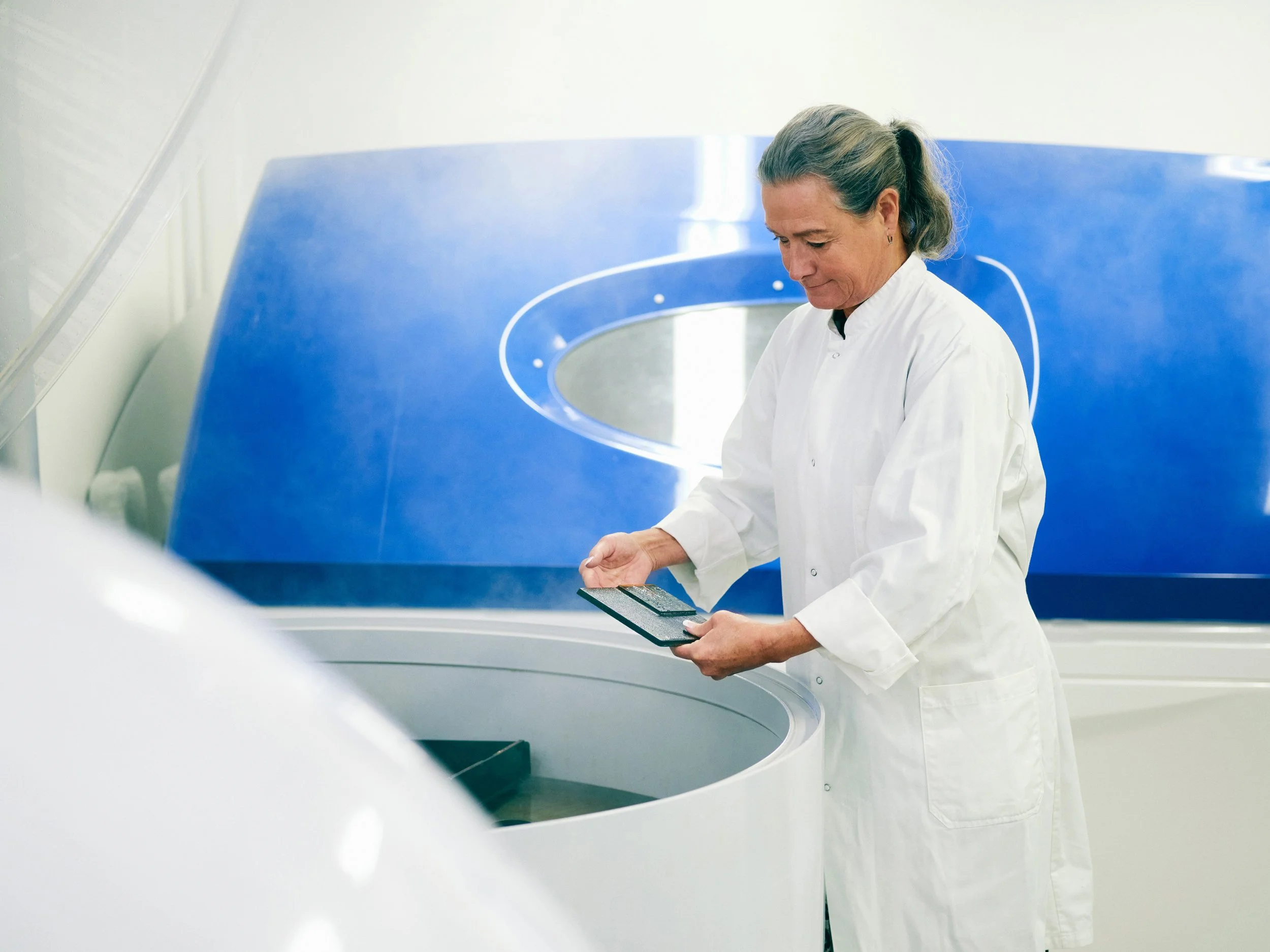 Researcher operating humidity testing tank 
