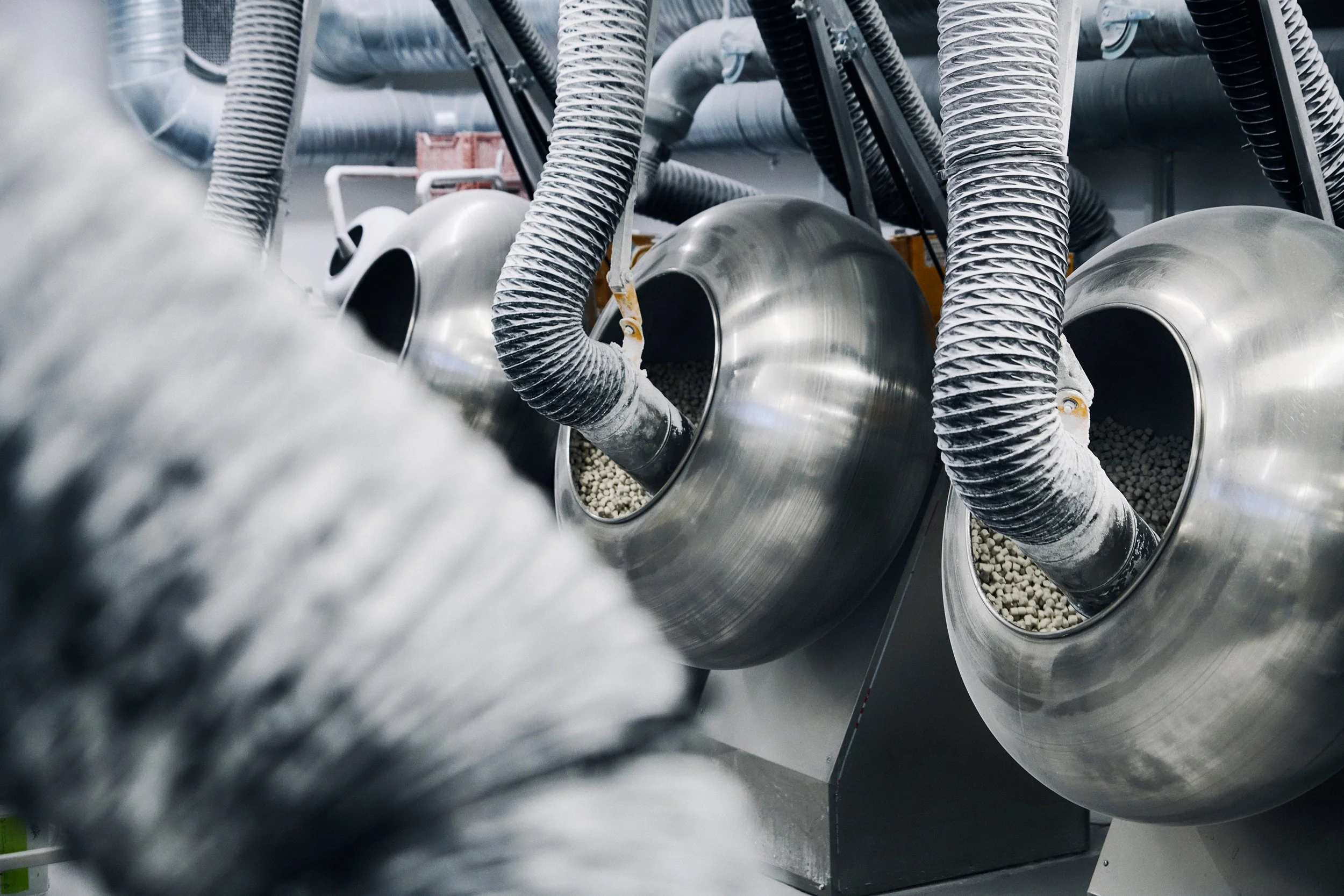 Close-up of industrial machinery with connected pipes and ducts, technical detail