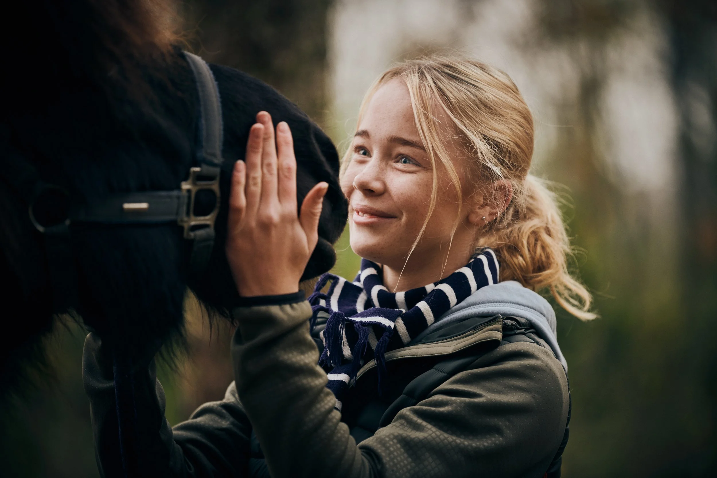 Girl interacting with horse, outdoor moment