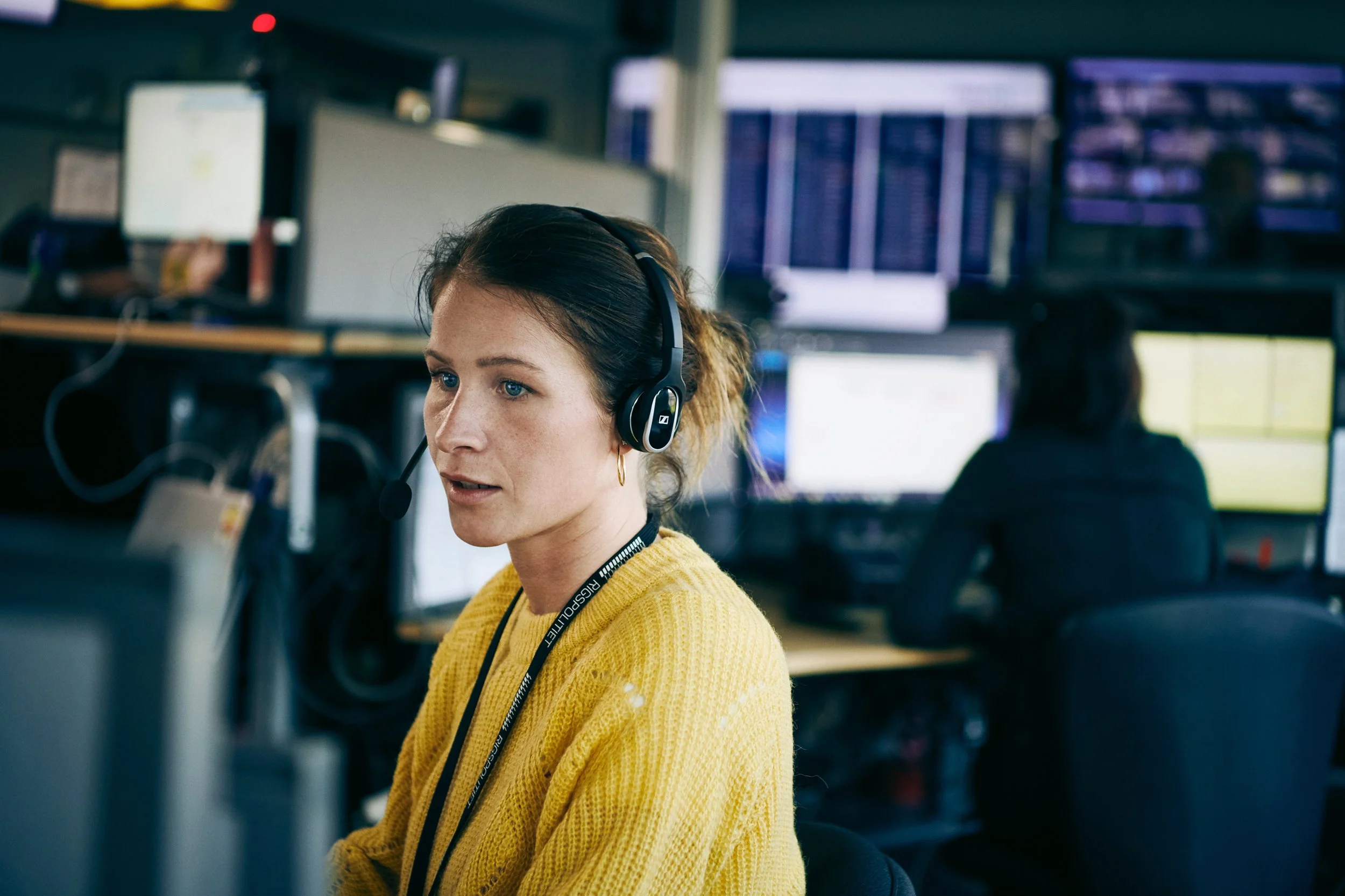 Emergency call operator wearing headset in control room
