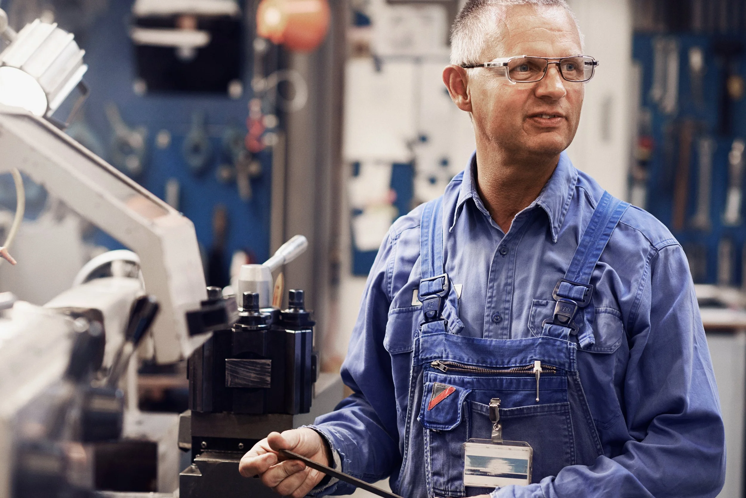 Technician operating industrial machine in production environment