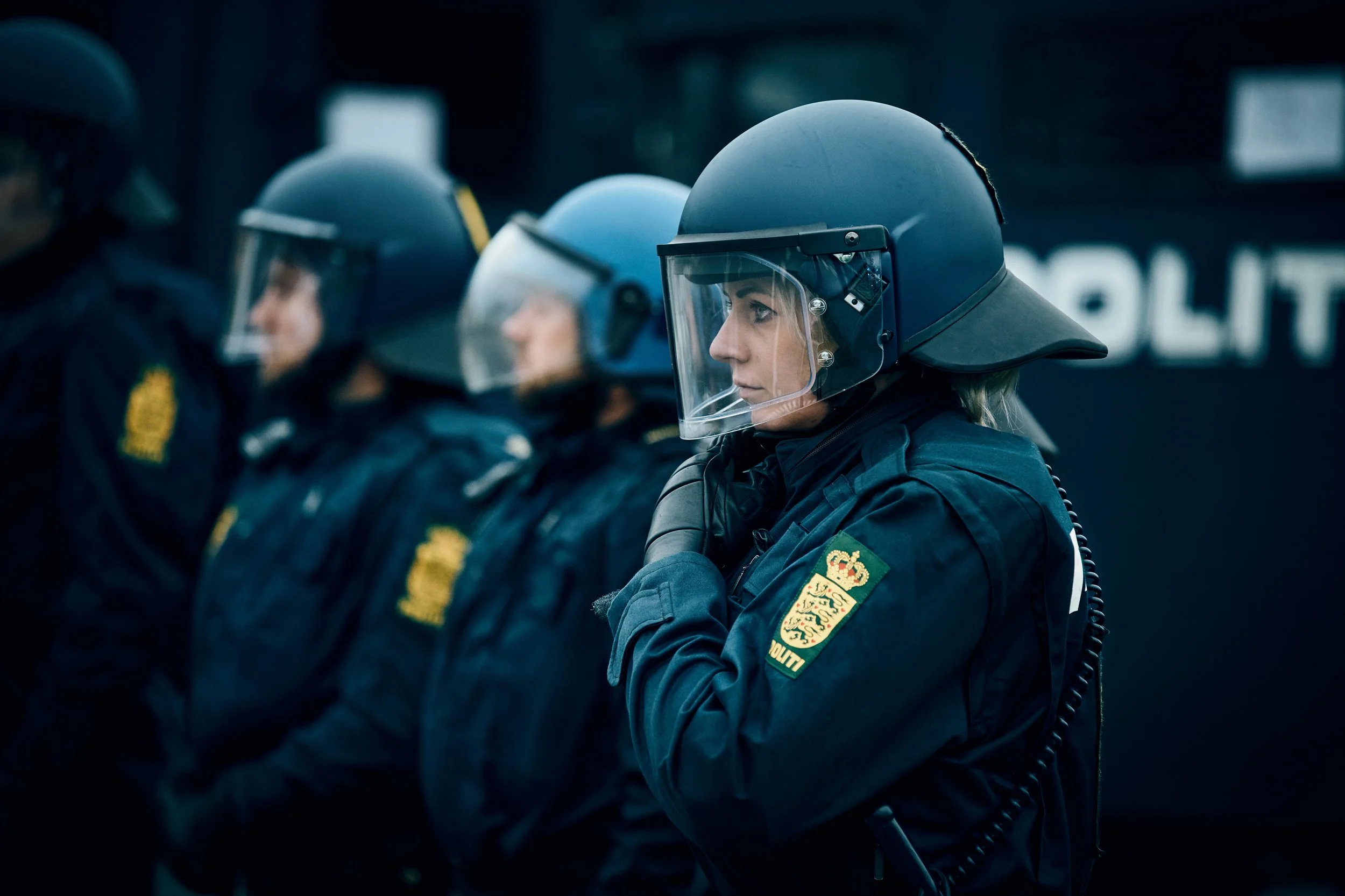 Police officers in patrol car driving through urban environment