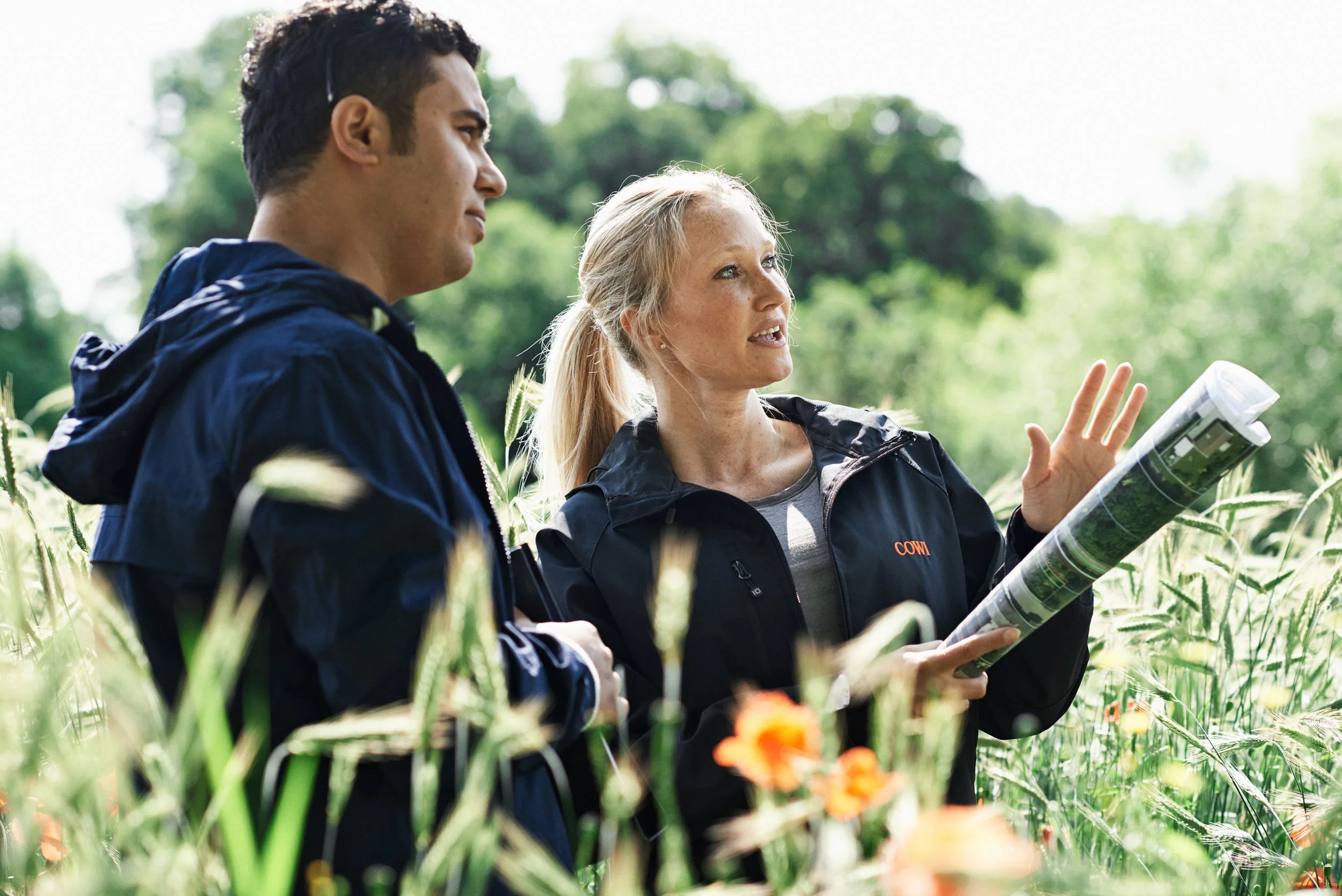 Two engineers reviewing plans outdoors in landscape
