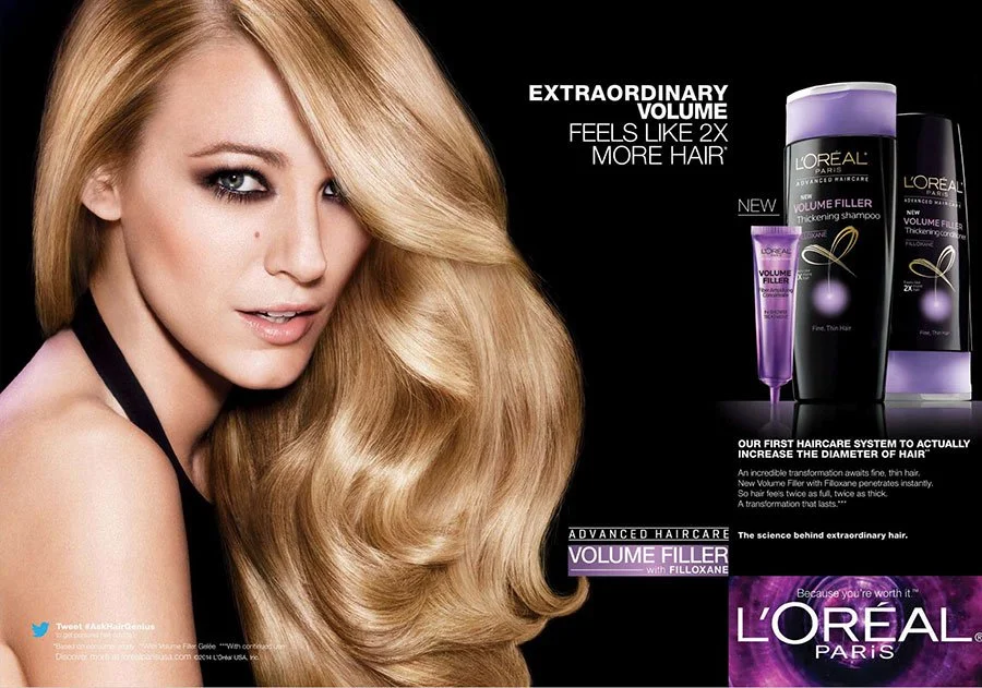 A blonde woman with voluminous hair next to an advertisement for L'Oréal Paris haircare products, including shampoo and thickening treatment, promoting enhanced hair volume.