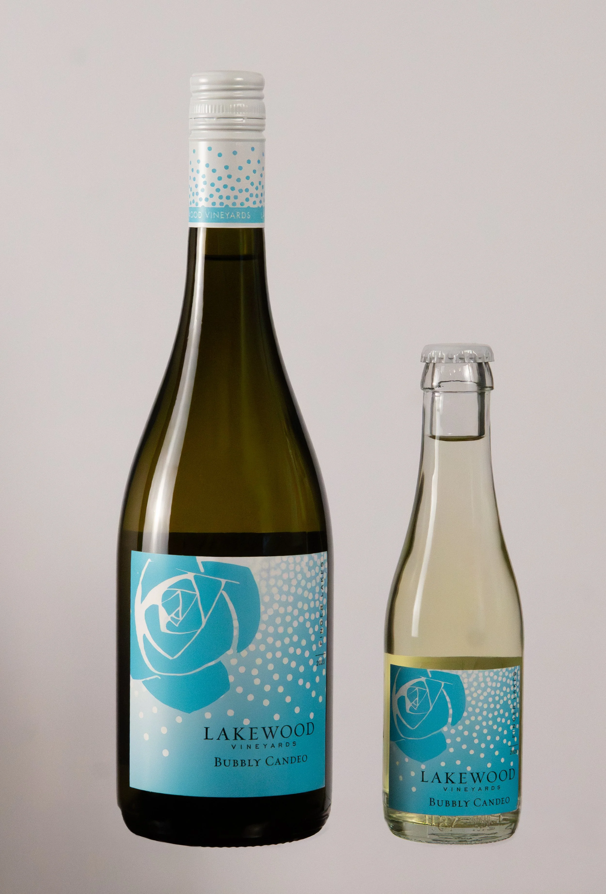 Two bottles of Lakewood Vineyards Bubbly Candeo, a sparkling wine, one larger and one smaller, against a plain background.
