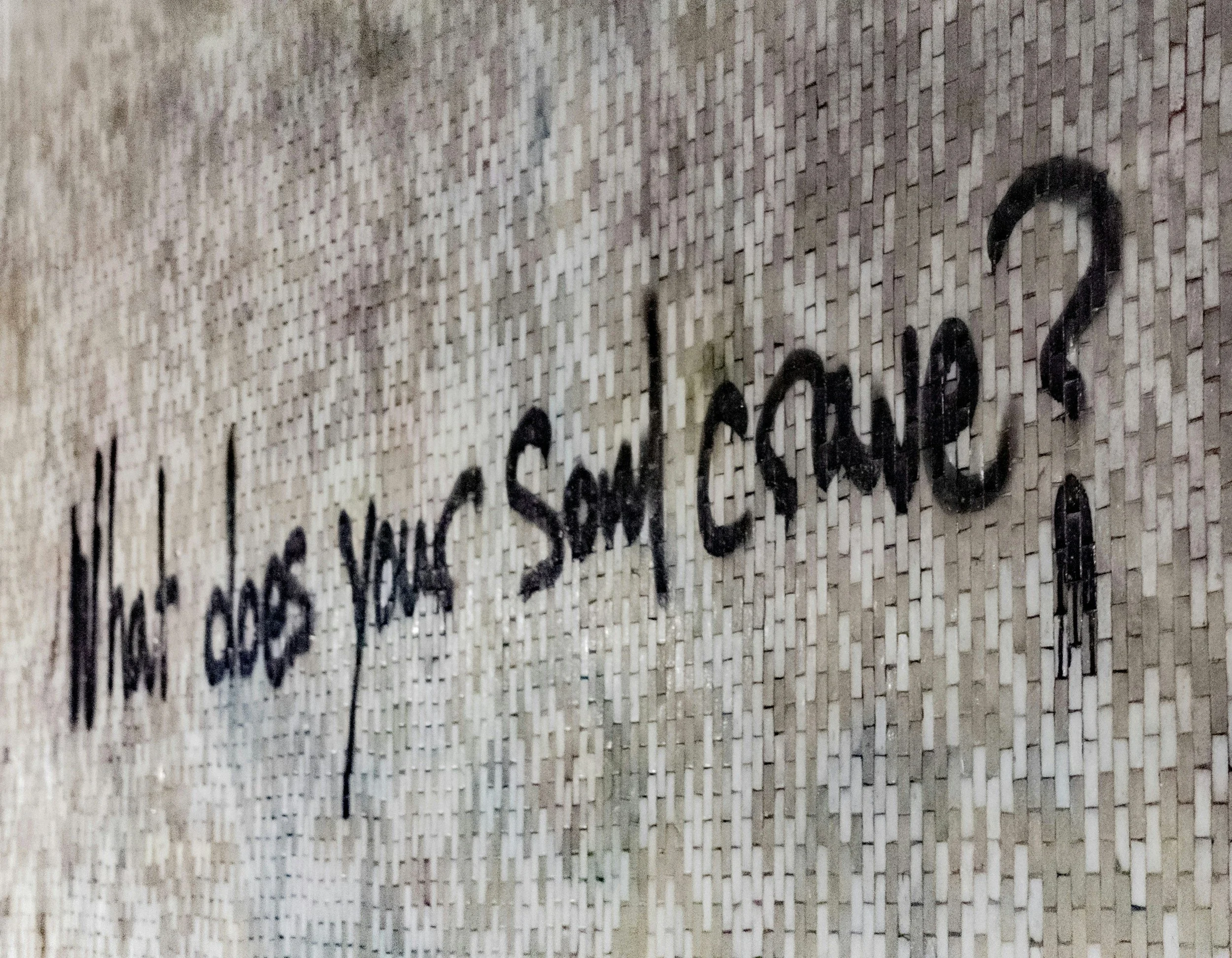 Close-up of a textured beige surface with handwritten black text that is partially visible.