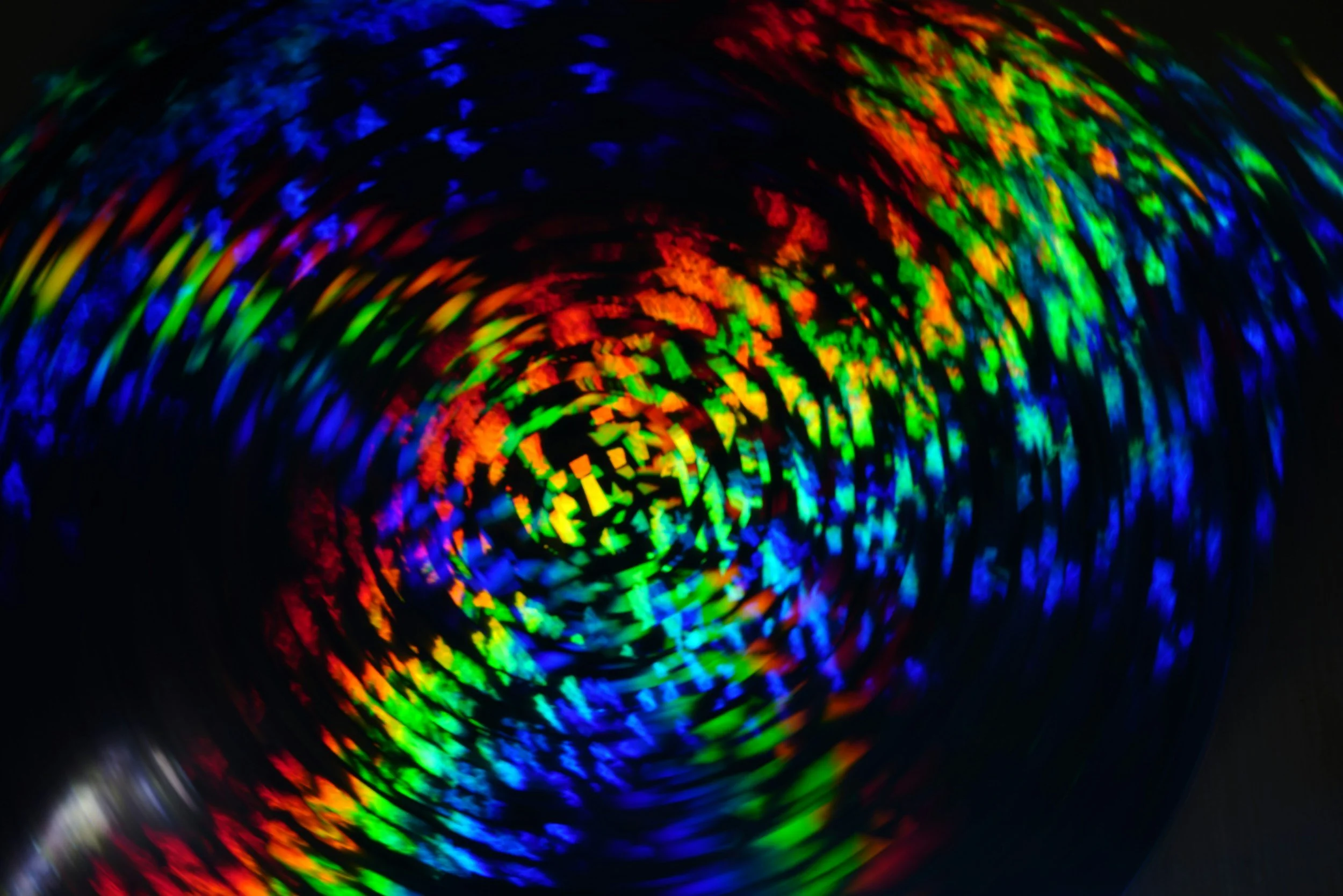 Colorful printed holographic tape with a spiral pattern of rainbow colors.